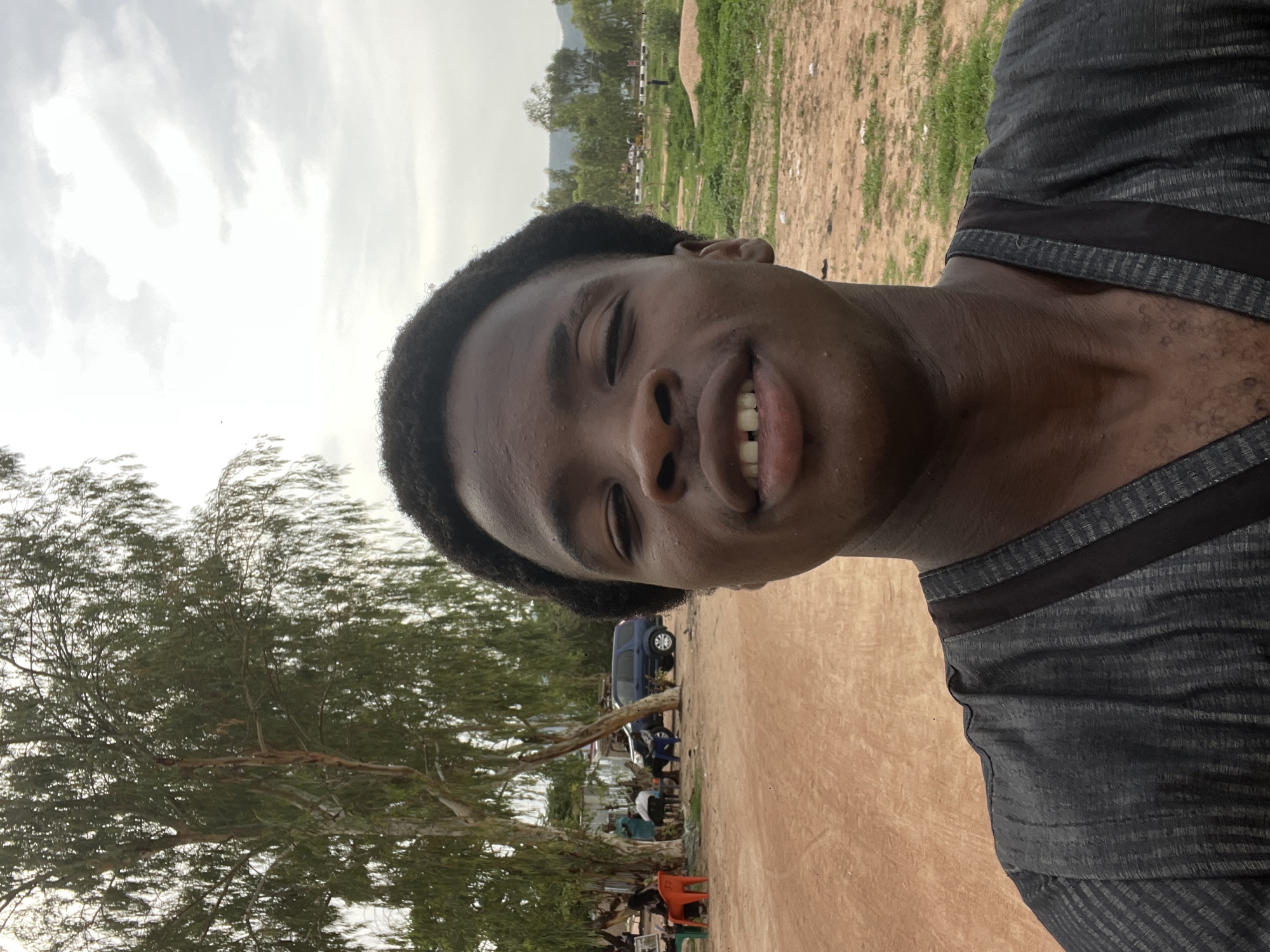 Young man takes selfie near gathering in Kporva, Nigeria