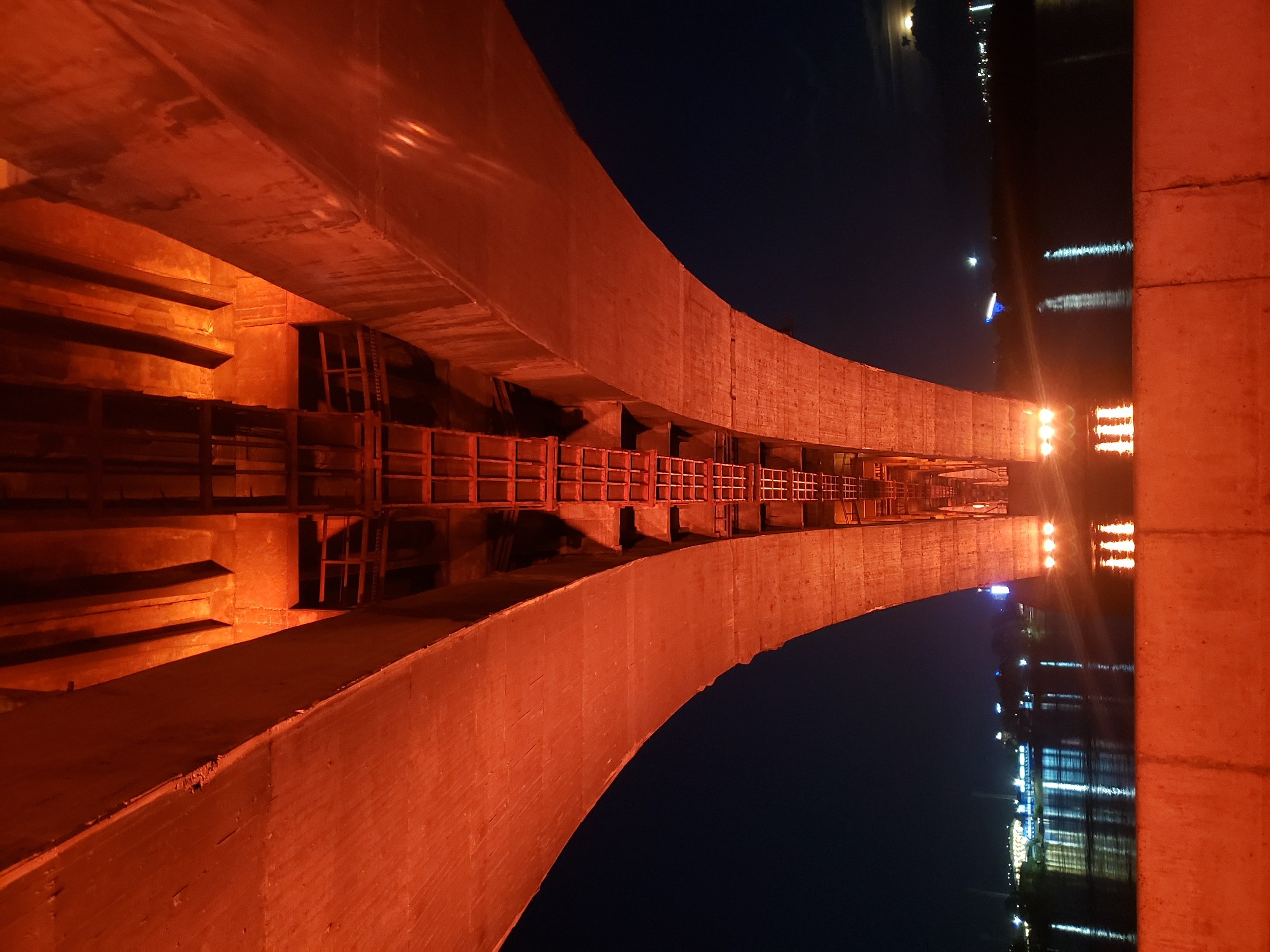Night out: bridge lights, glowing spheres, and rental scooters