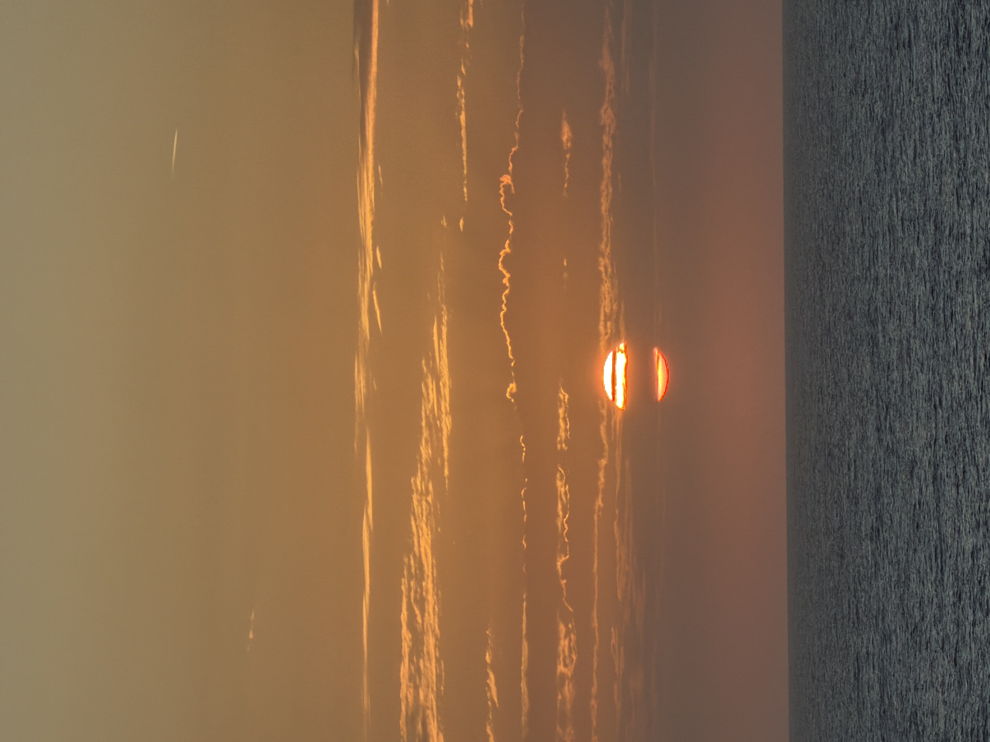Gulf sunset captured with offshore oil platforms visible