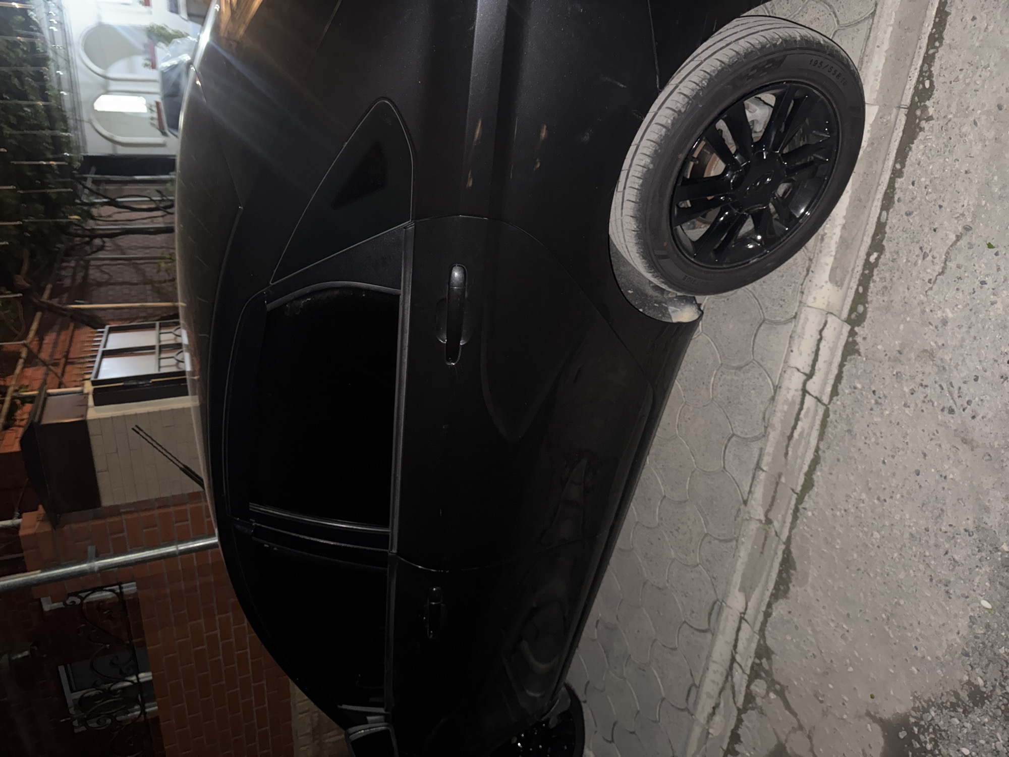 Person enters, inspects and starts black Lada vehicle at night