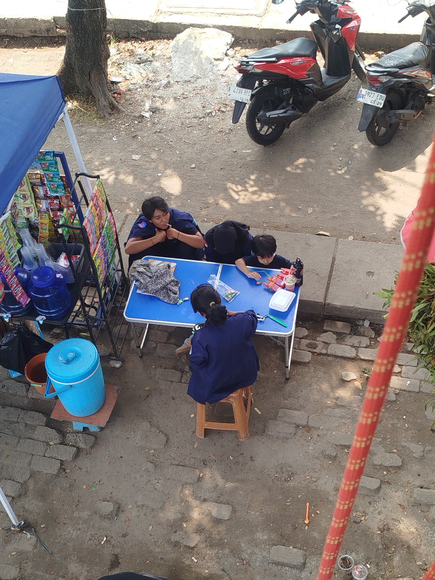 Depok street life and a littered waterway on a summer morning