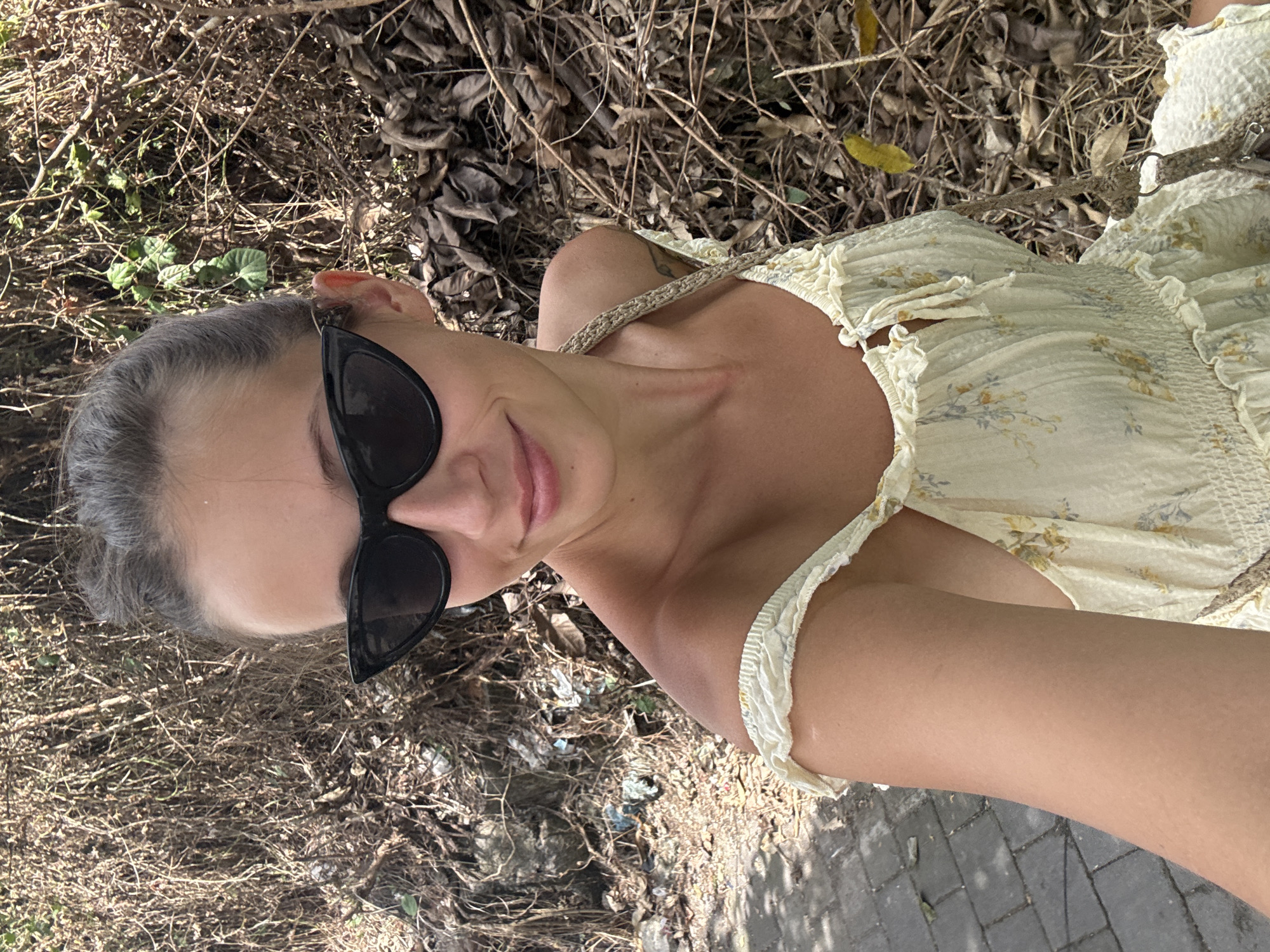 Woman in floral dress photographed outdoors in Mengwi, Indonesia
