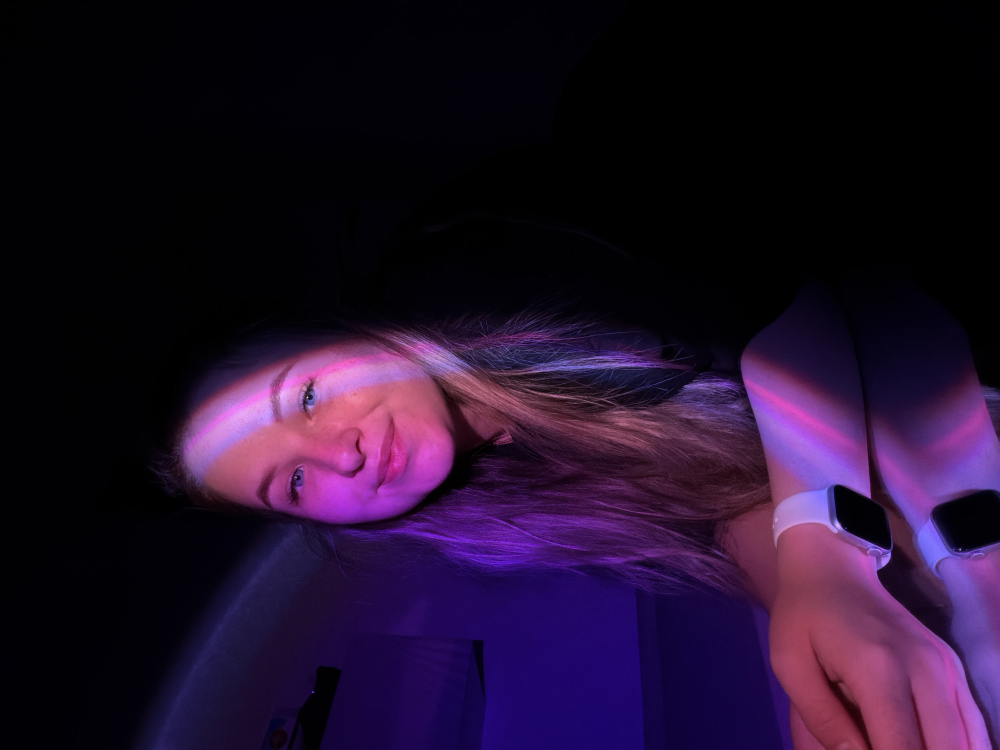 Woman and cat photographed in colorful indoor lighting session