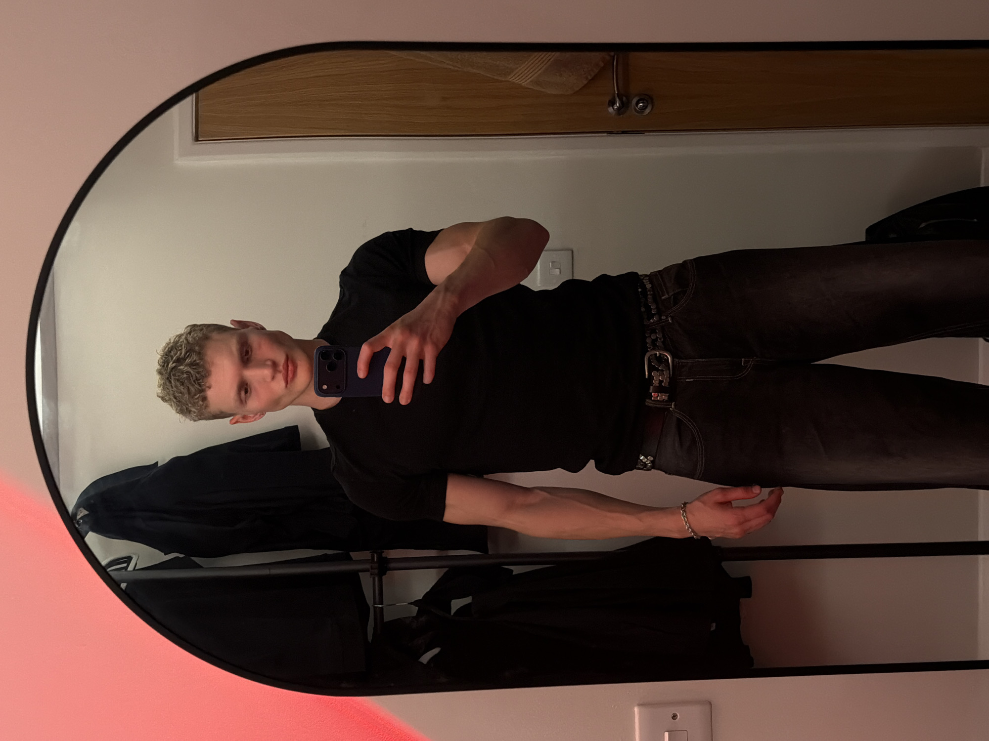 Mirror selfies in a red-lit London room, two minutes apart.