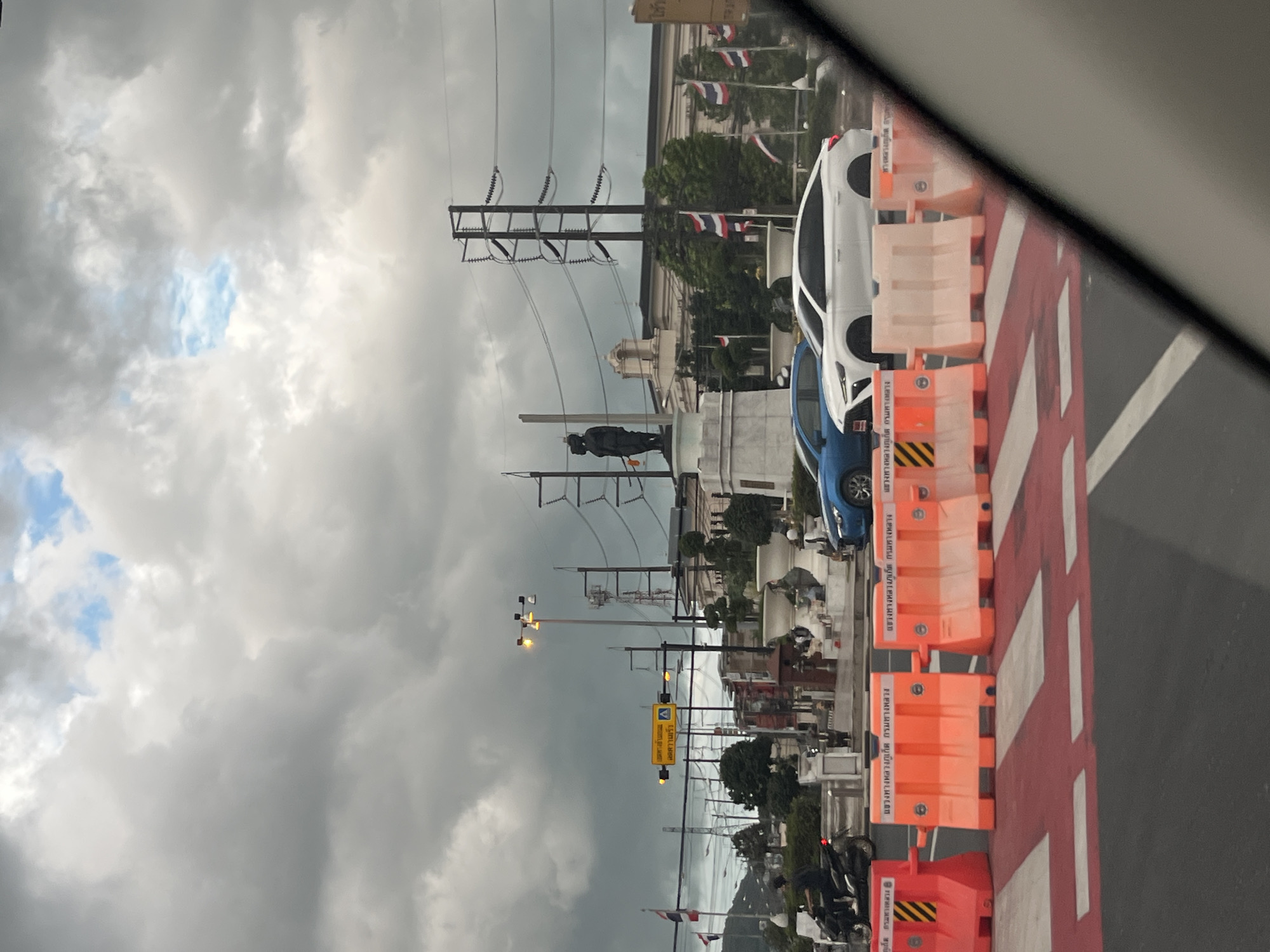 Routine traffic navigates construction barriers in Si Sunthon, Thailand