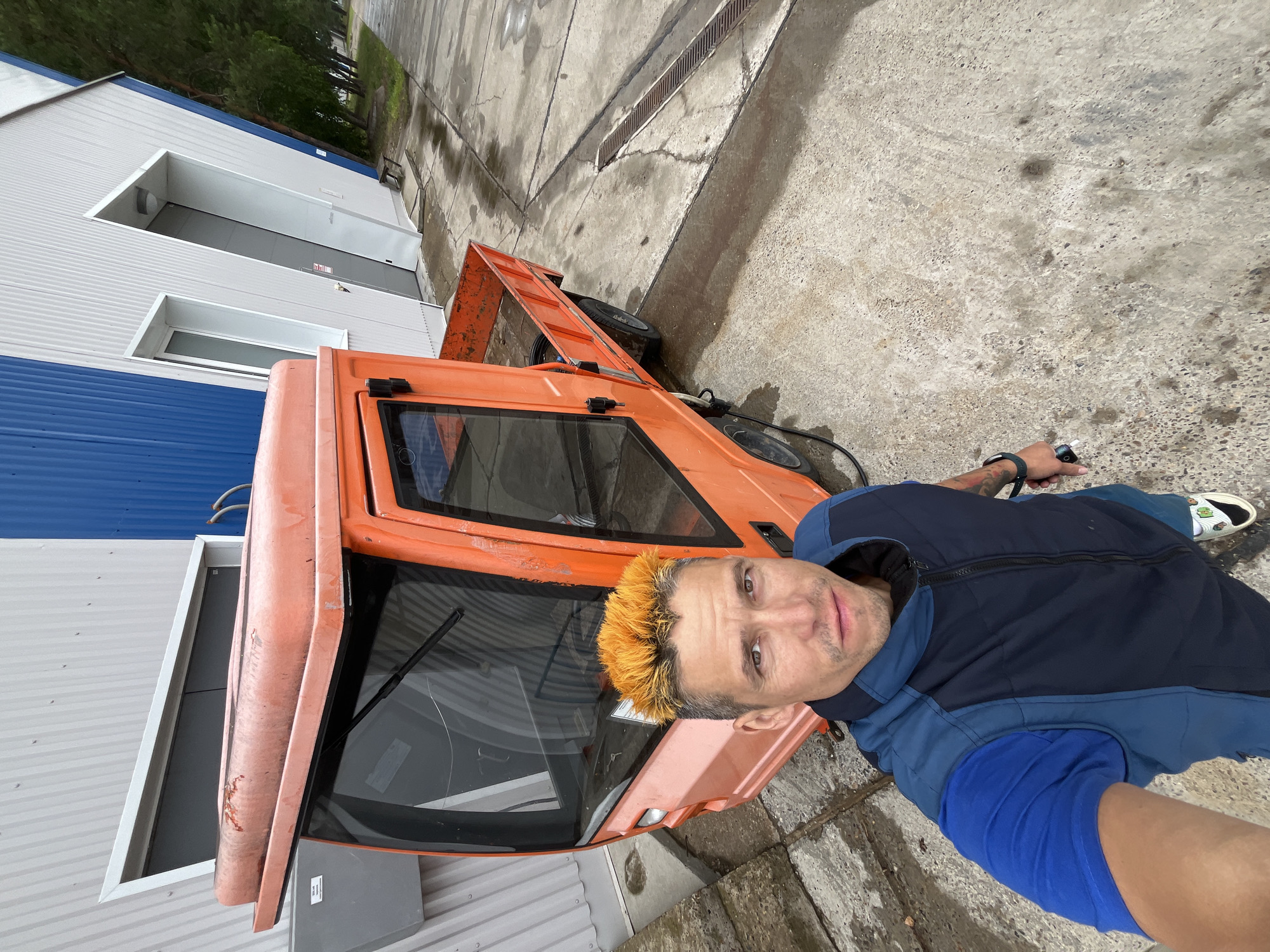 Selfies with an orange utility vehicle in Chaikovsky, Russia