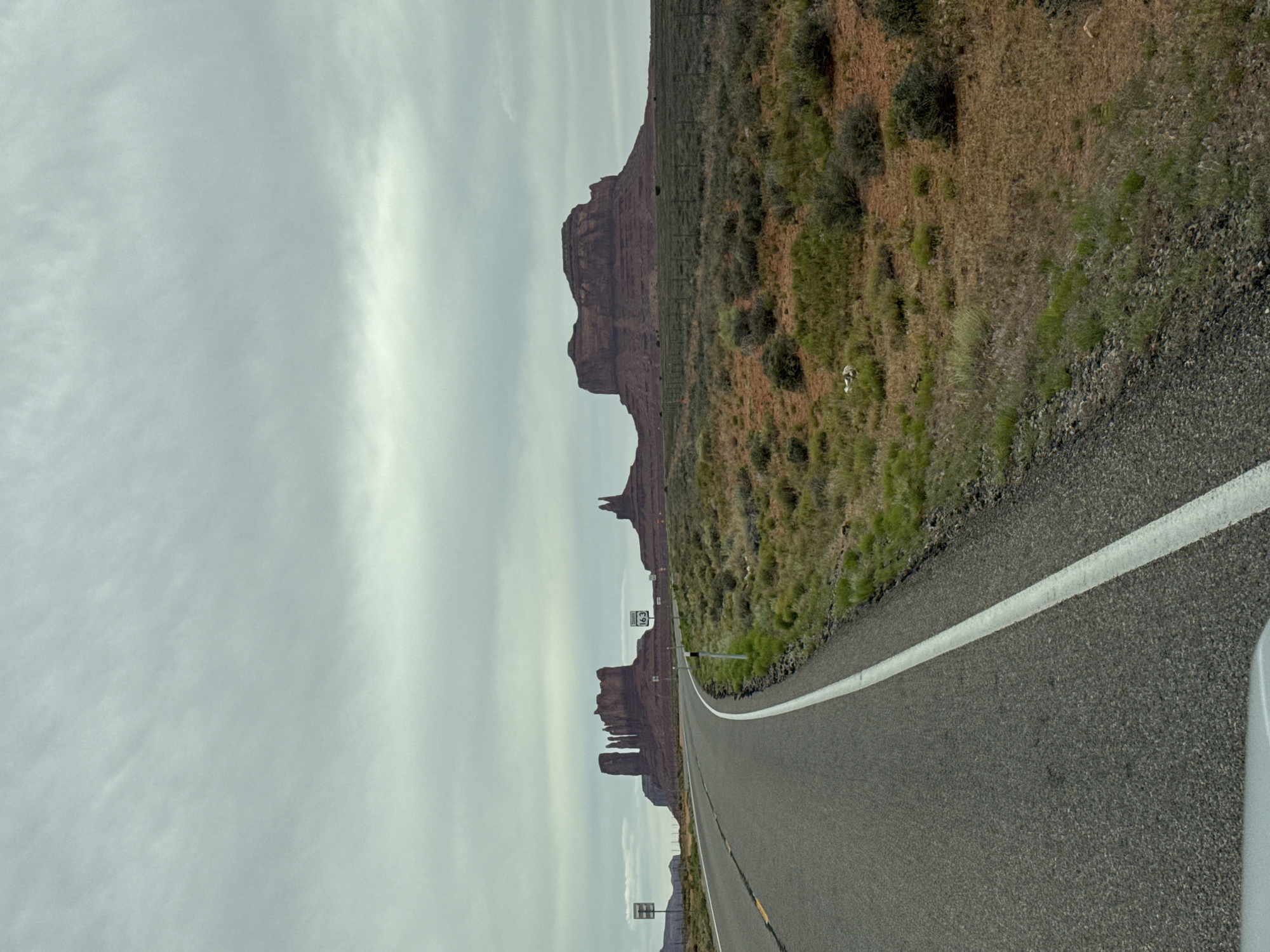 Woman in cowboy hat photographed during desert road trip