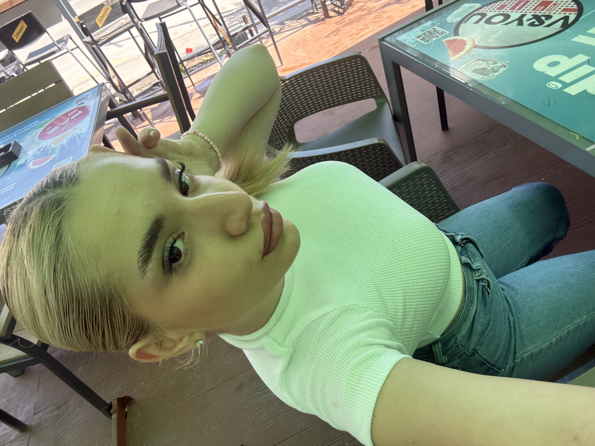 Woman takes morning selfies at Sofia cafe