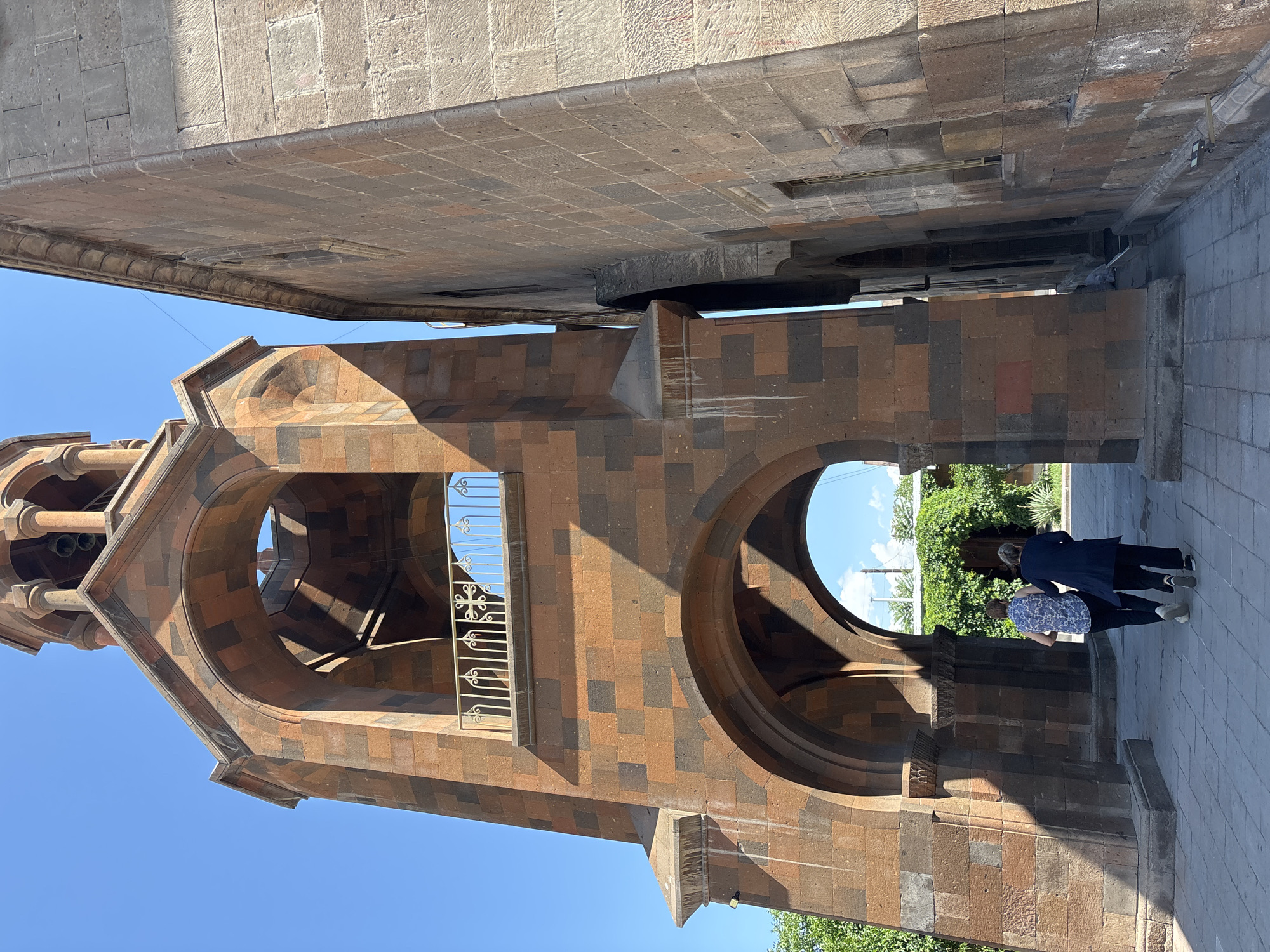 Morning documentation of Armenian religious site architecture and ceremonial candles