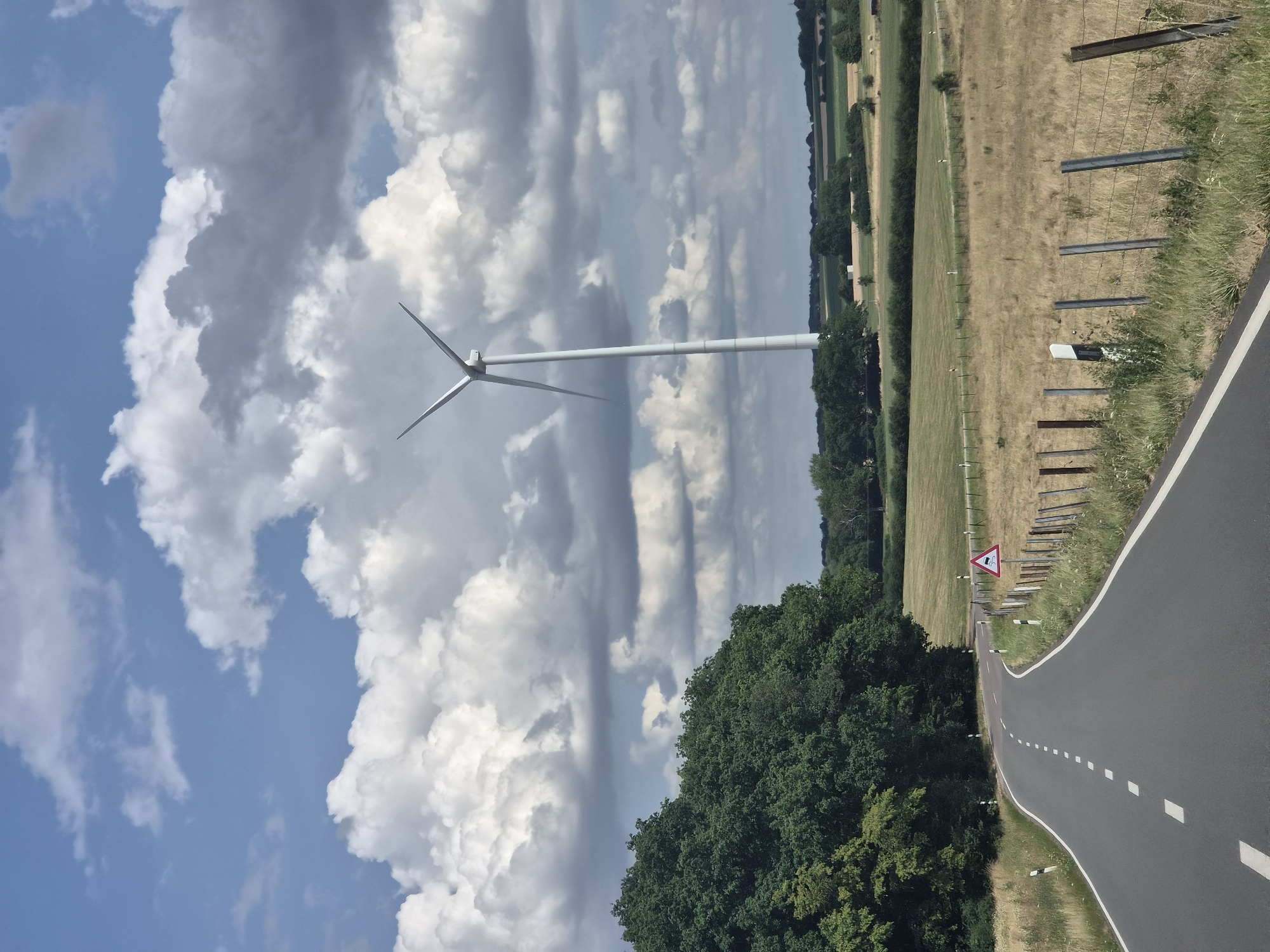 Stationary wind turbine rises above Luxembourg's rolling rural countryside