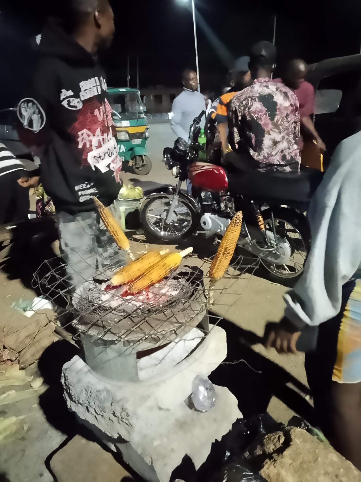 Evening outdoor gathering features grilling and social activities