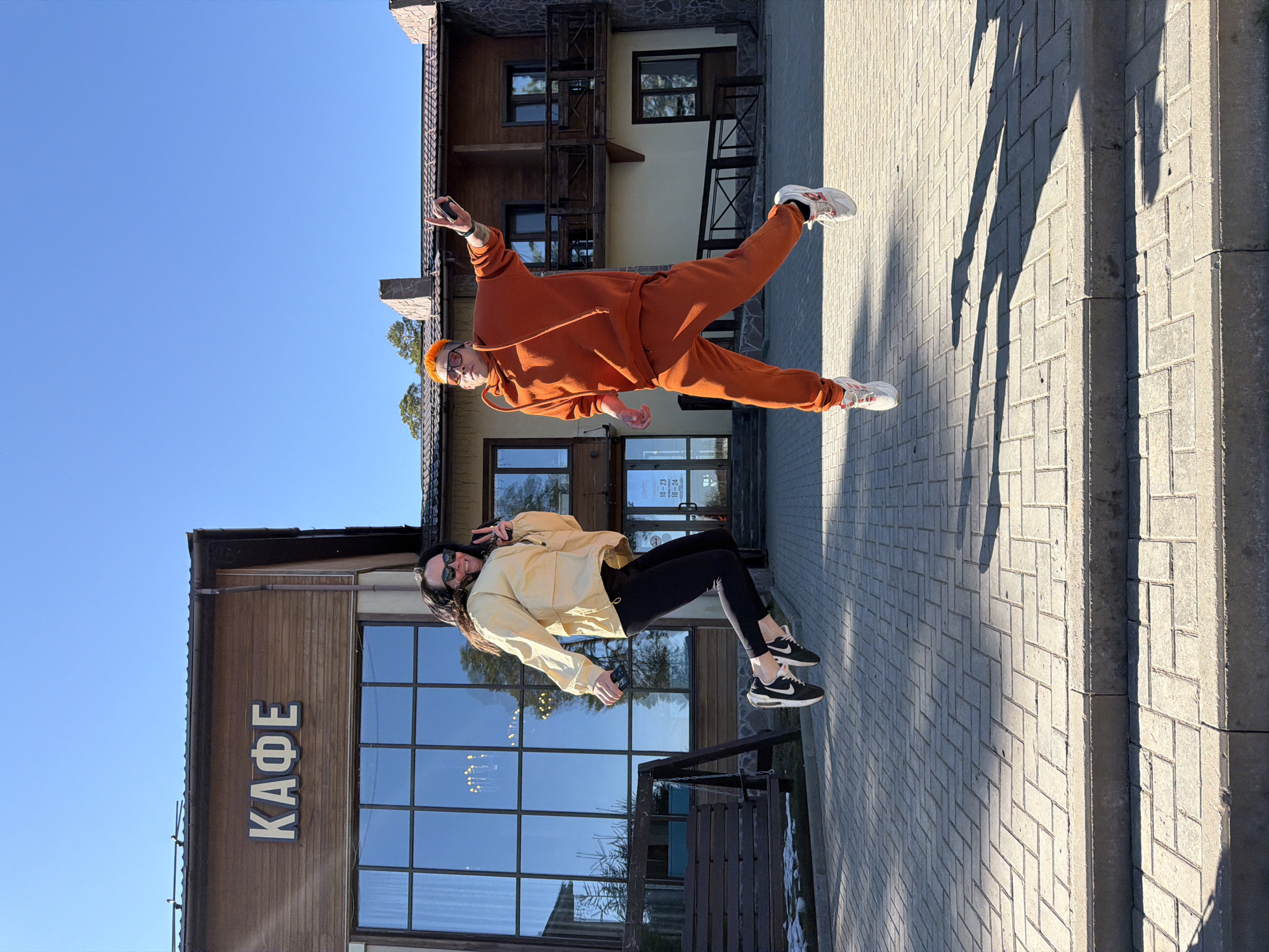 Two people pose playfully outside cafe in Votkinsk