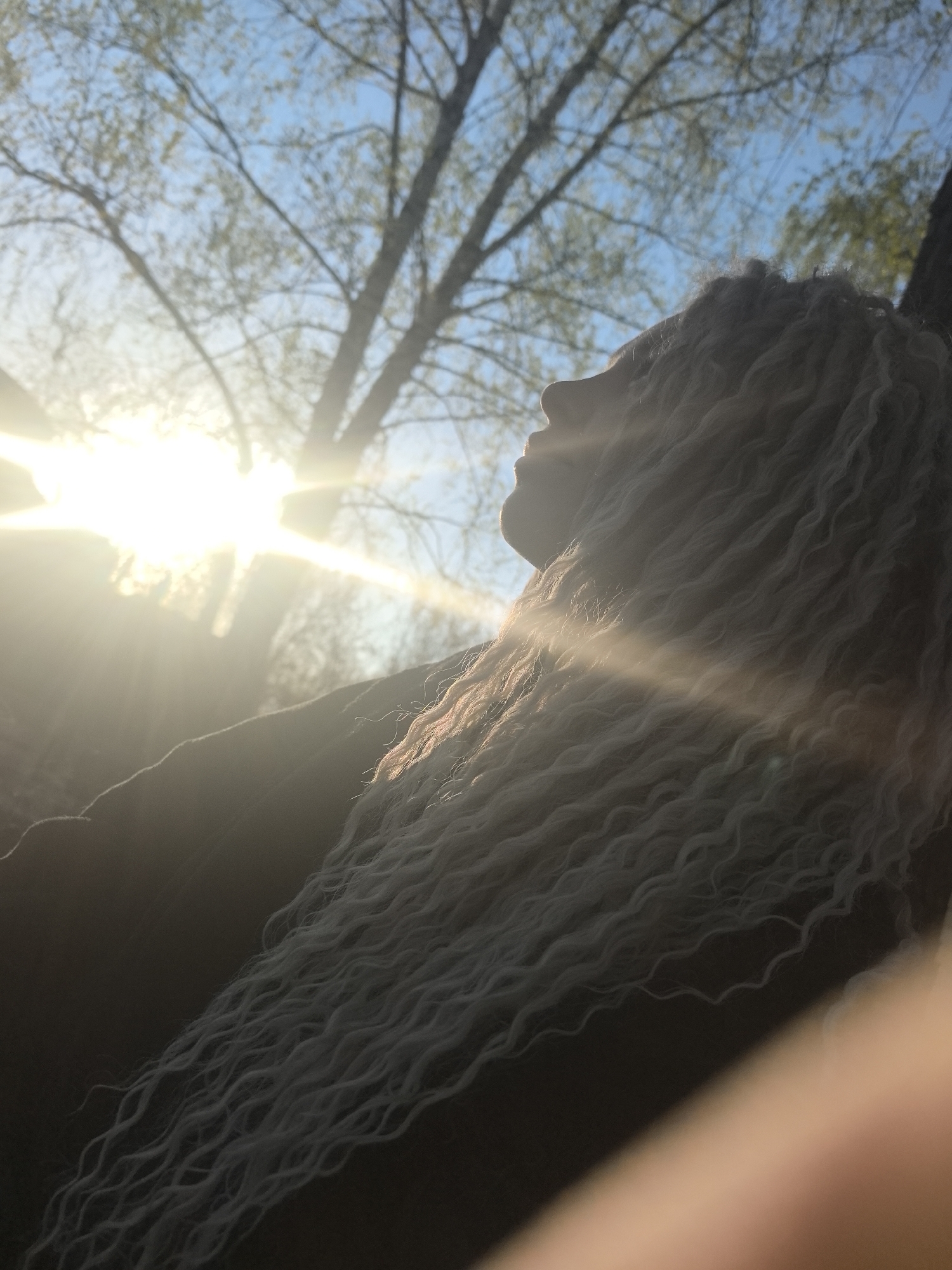Woman photographed in early morning lakeside setting in Noviy