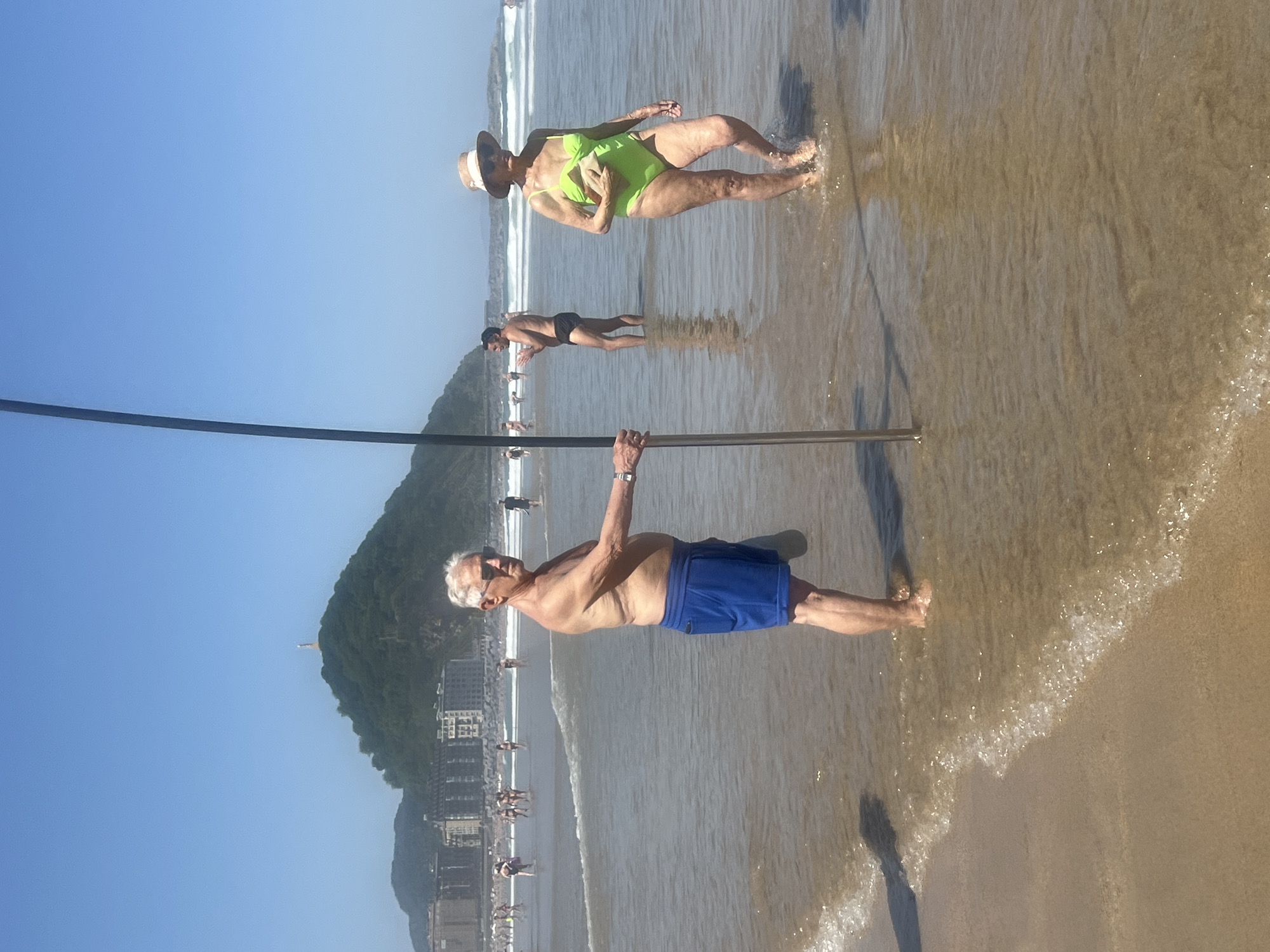 Lifeguard patrol and beachgoers at La Concha beach morning