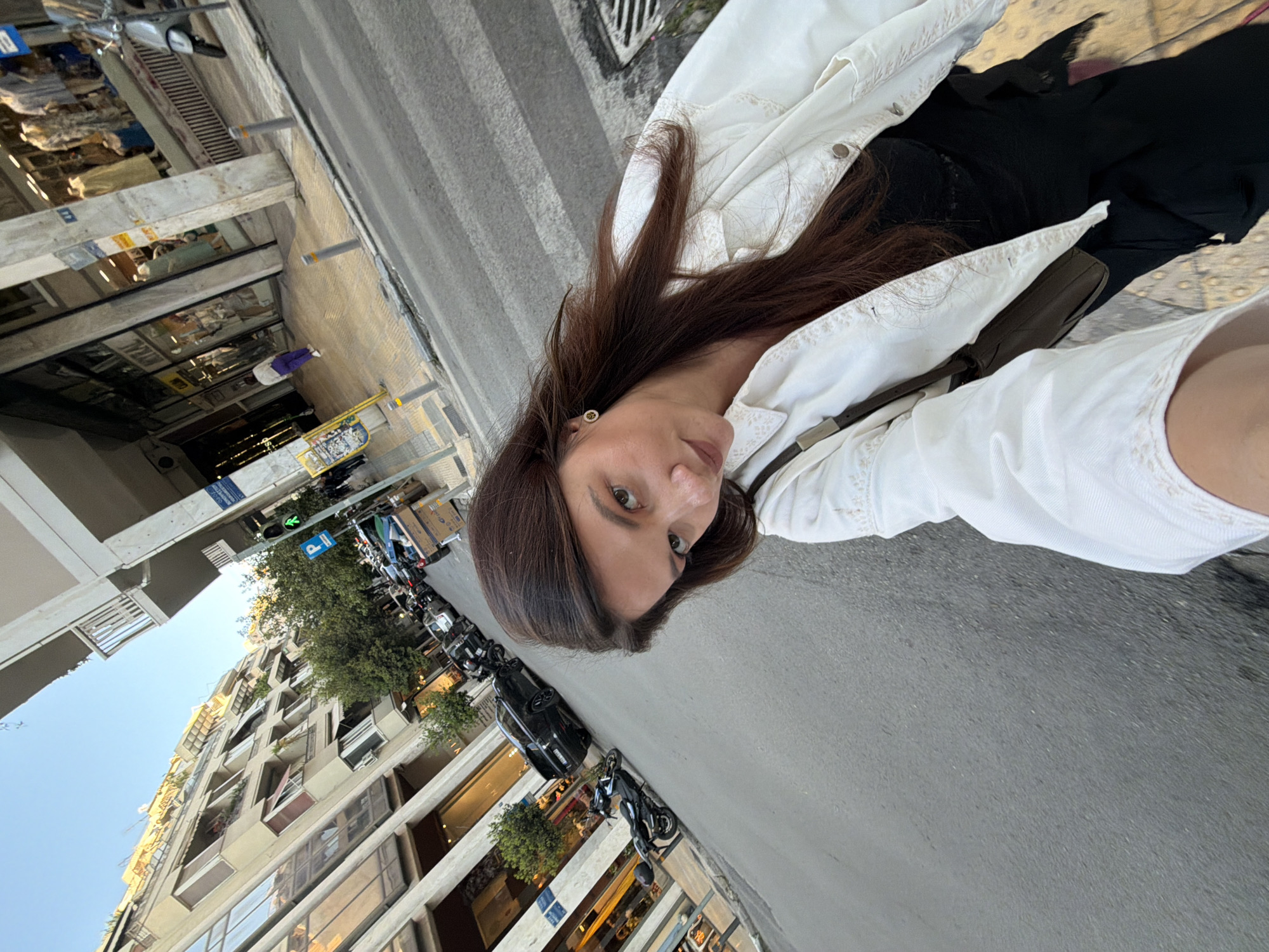 Woman documents Athens street walk with selfie