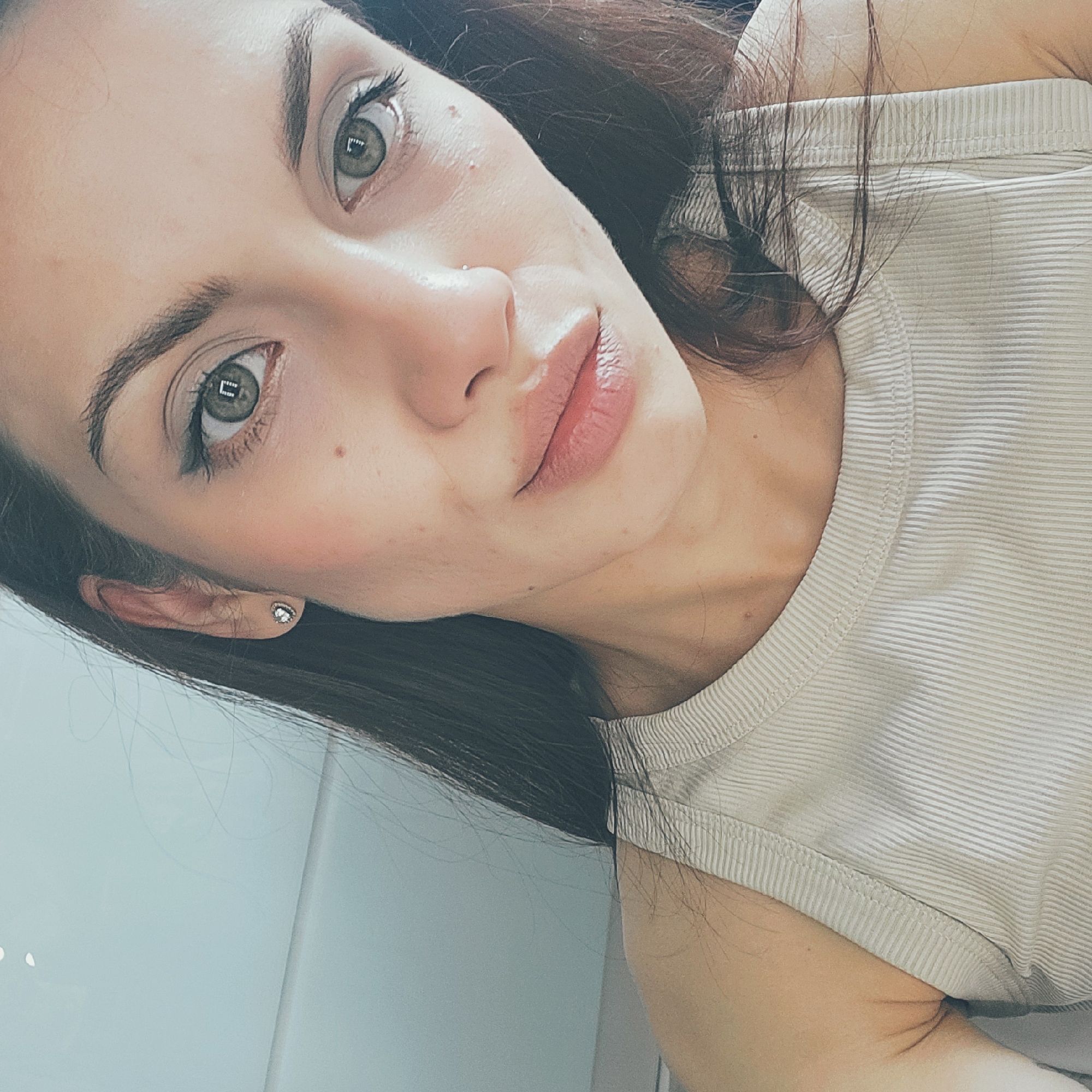 Close-up selfie series in Moscow, ribbed tank top and tattoo visible.