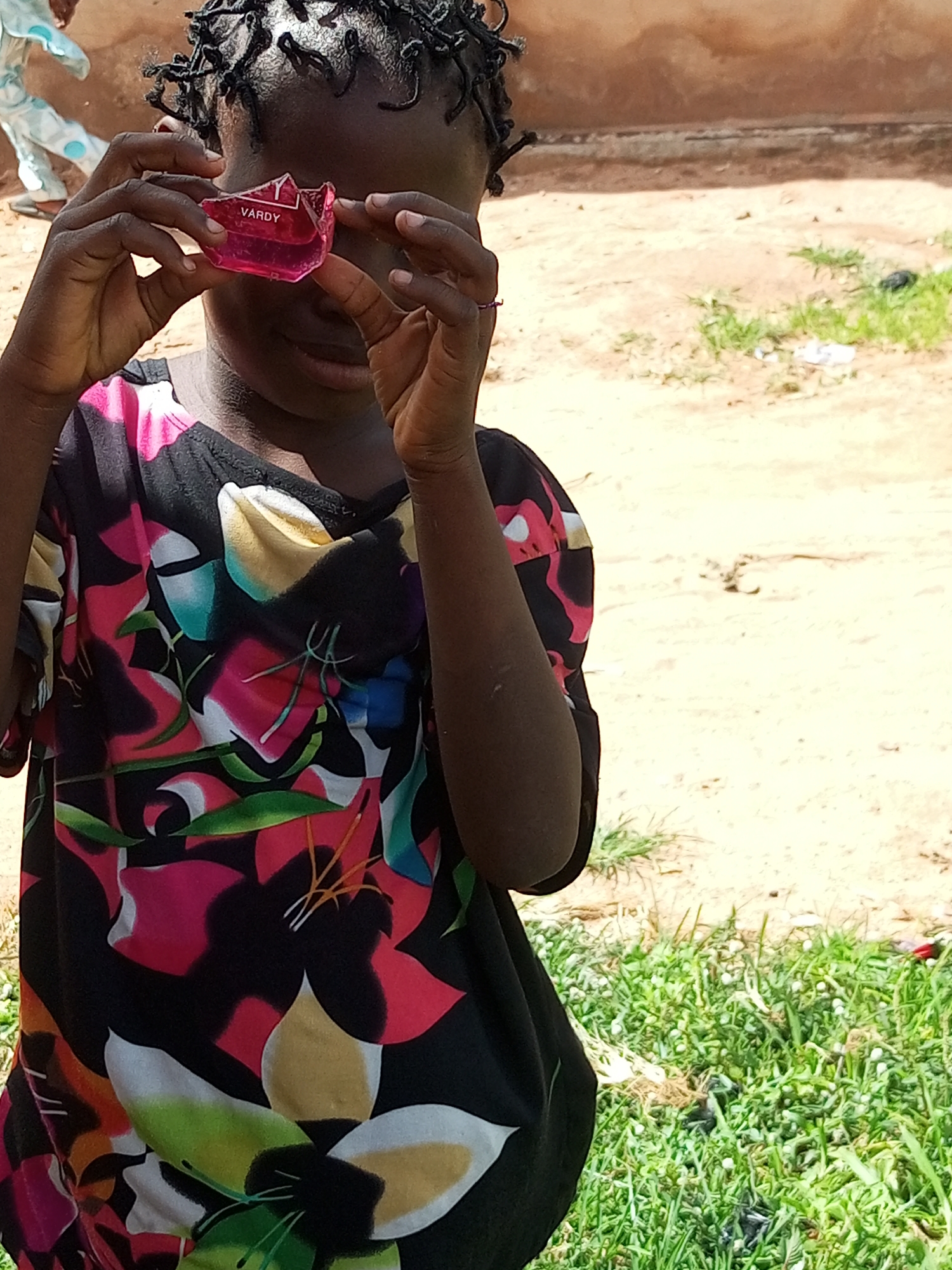 Playful outdoor moments: makeshift monocle, big smile, shirt buttons