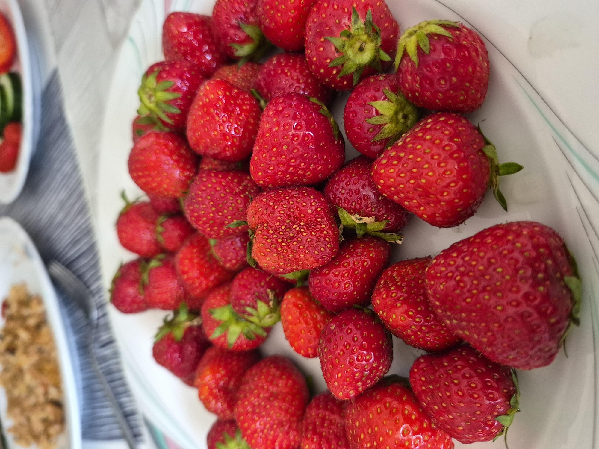 Fresh strawberries served up with an anime mug on the side