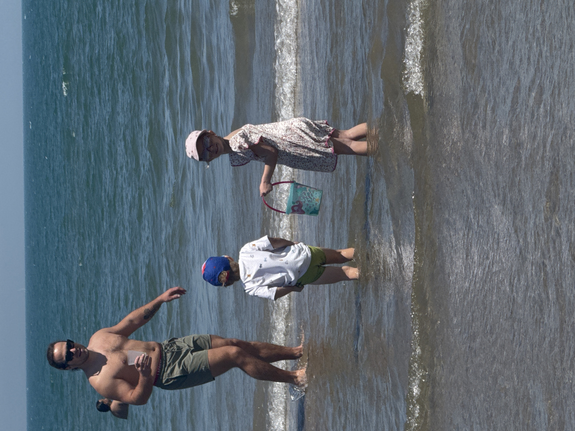 Family enjoys sunny beach day in Valencia, Spain