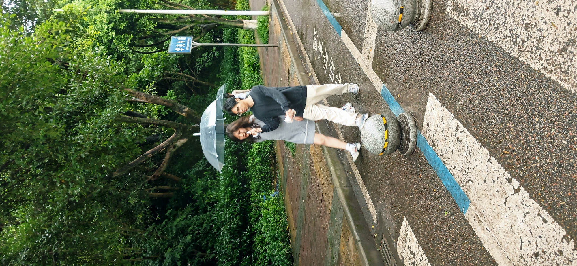 Couple walks with clear umbrella during nighttime rain in Chongqing
