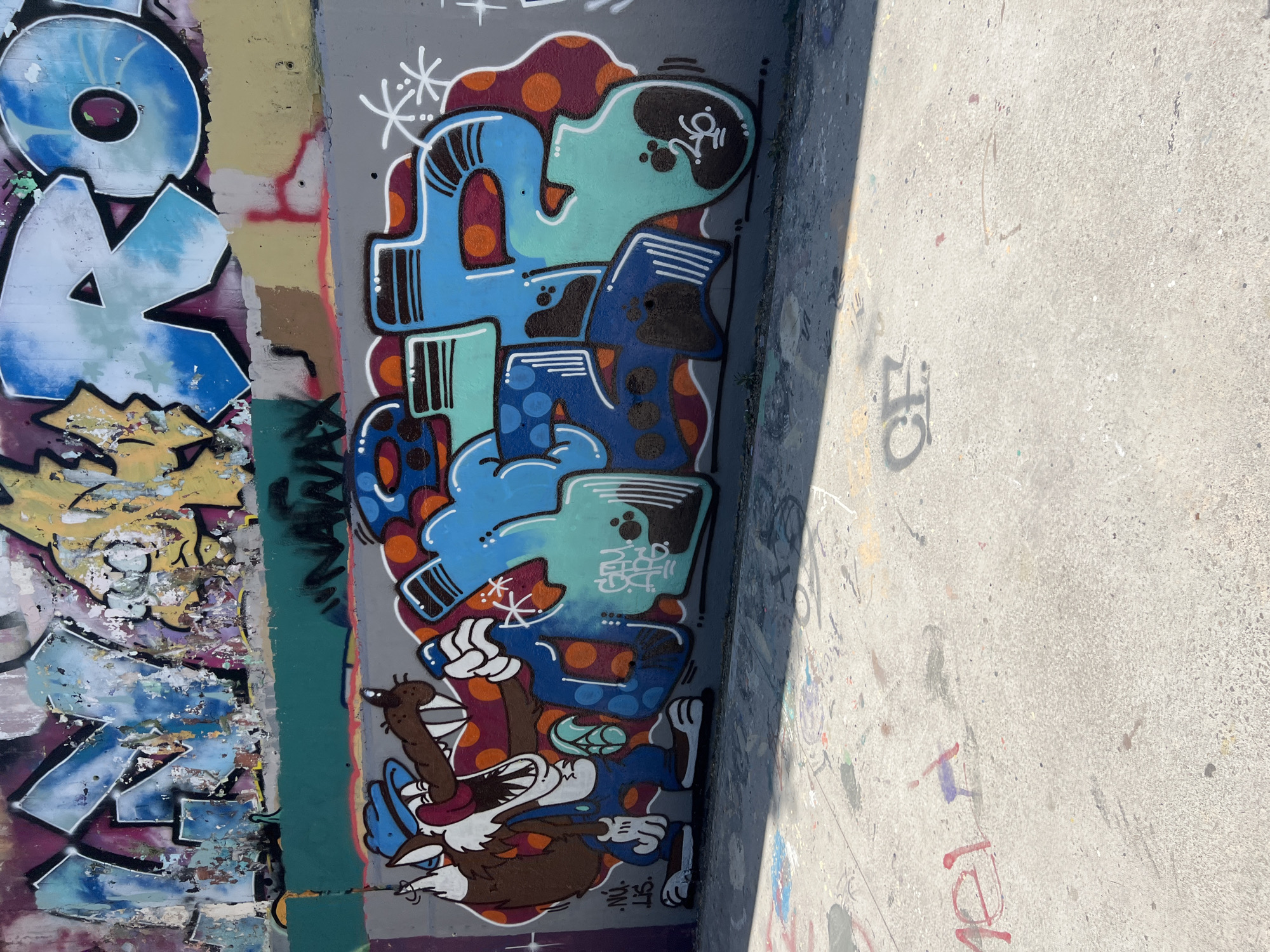 Barcelona skatepark walls covered in layered graffiti and murals