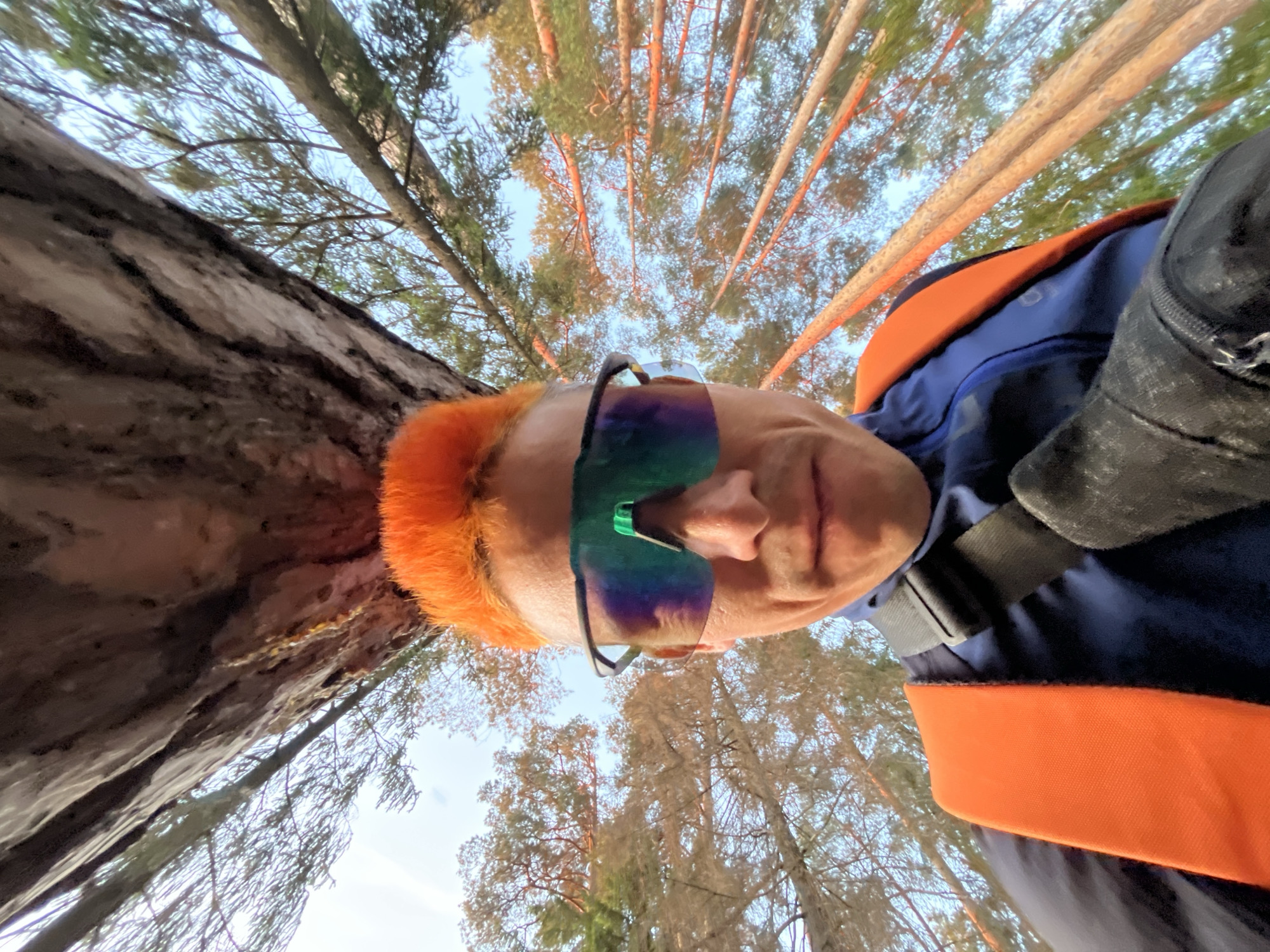 Orange-haired cyclist photographed in Chaikovsky forest with red bicycle