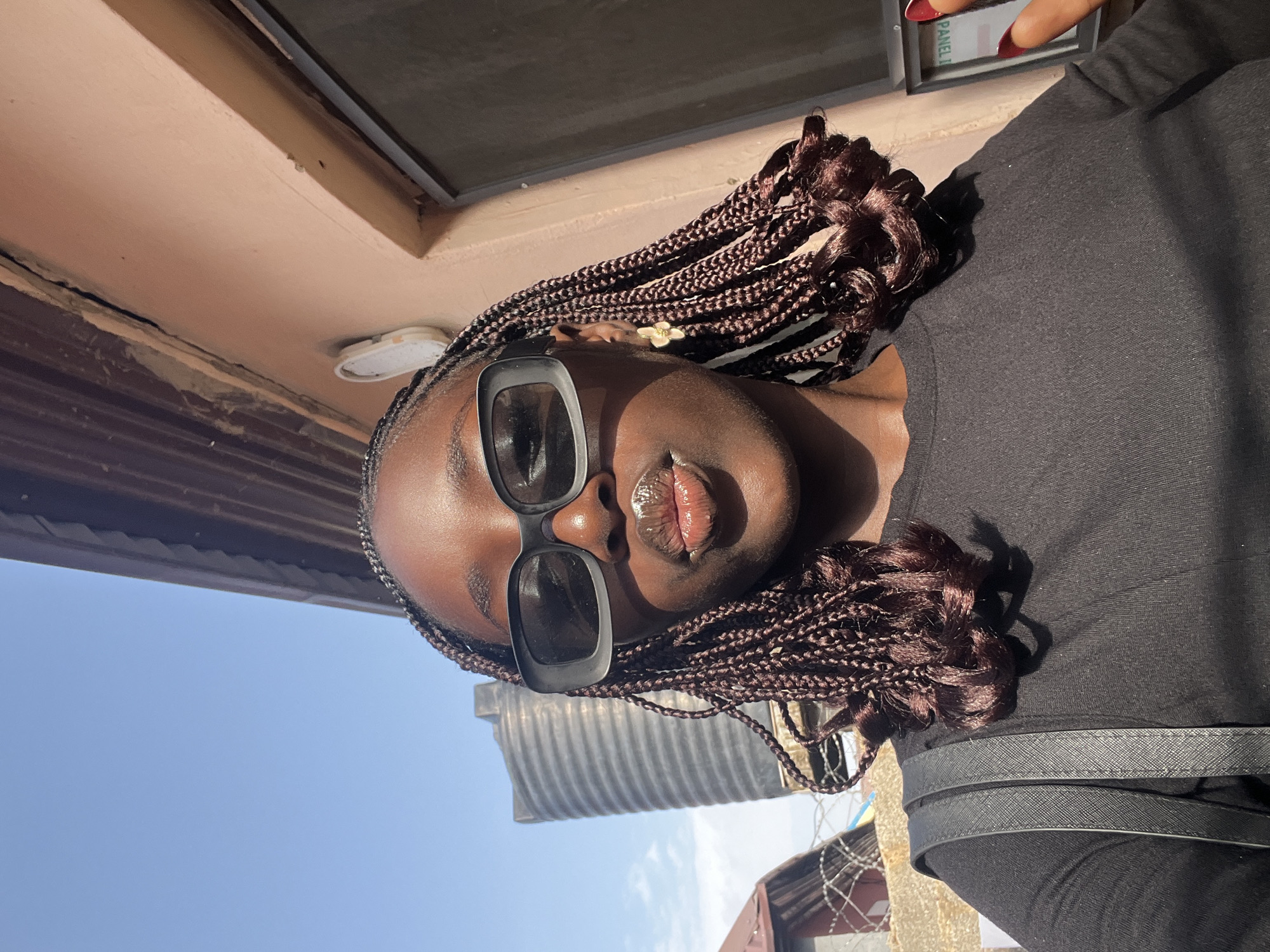 Woman in sunglasses observed near water tank in Abuja
