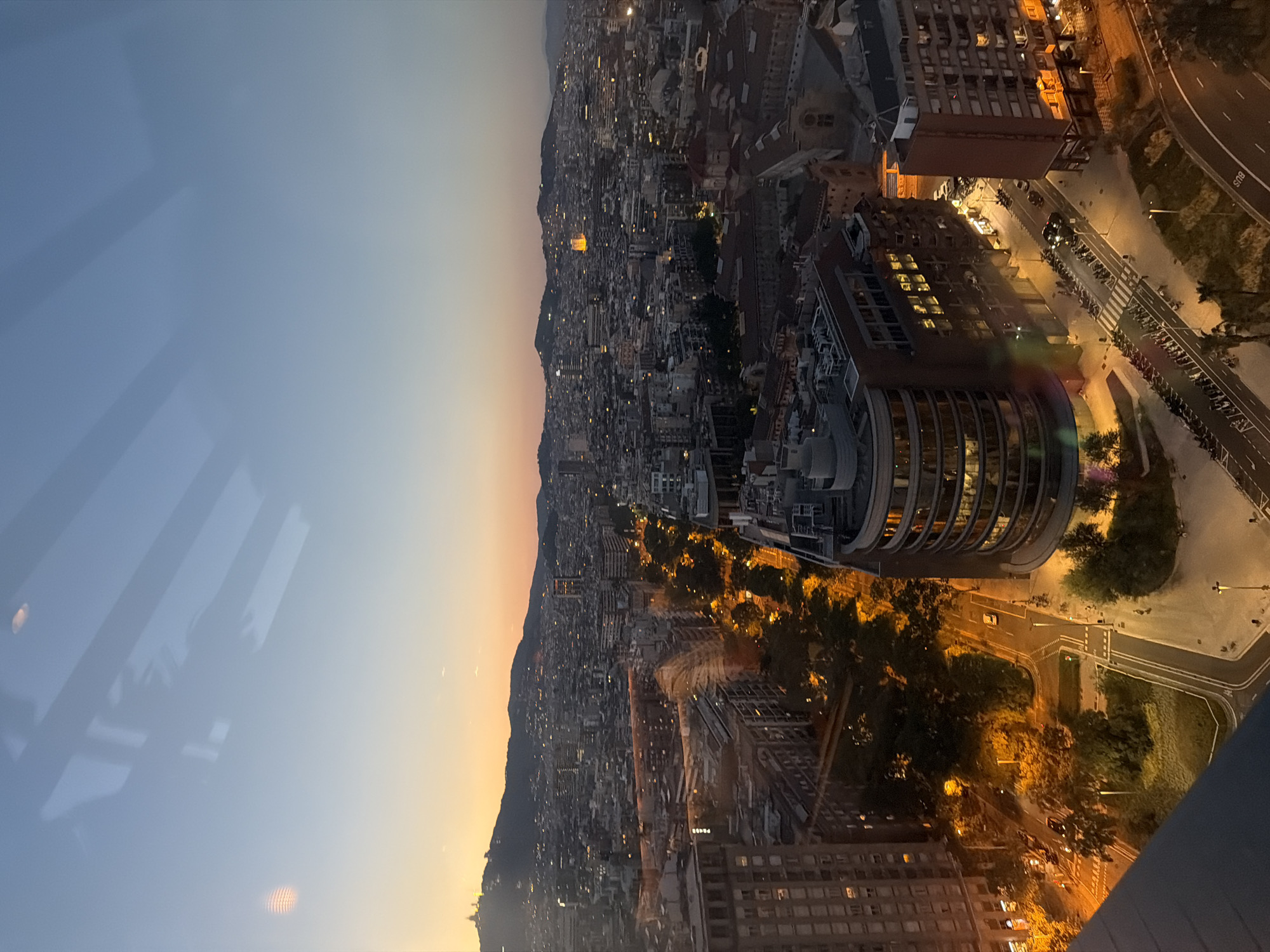 Rooftop evening in Barcelona with skyline and moonrise