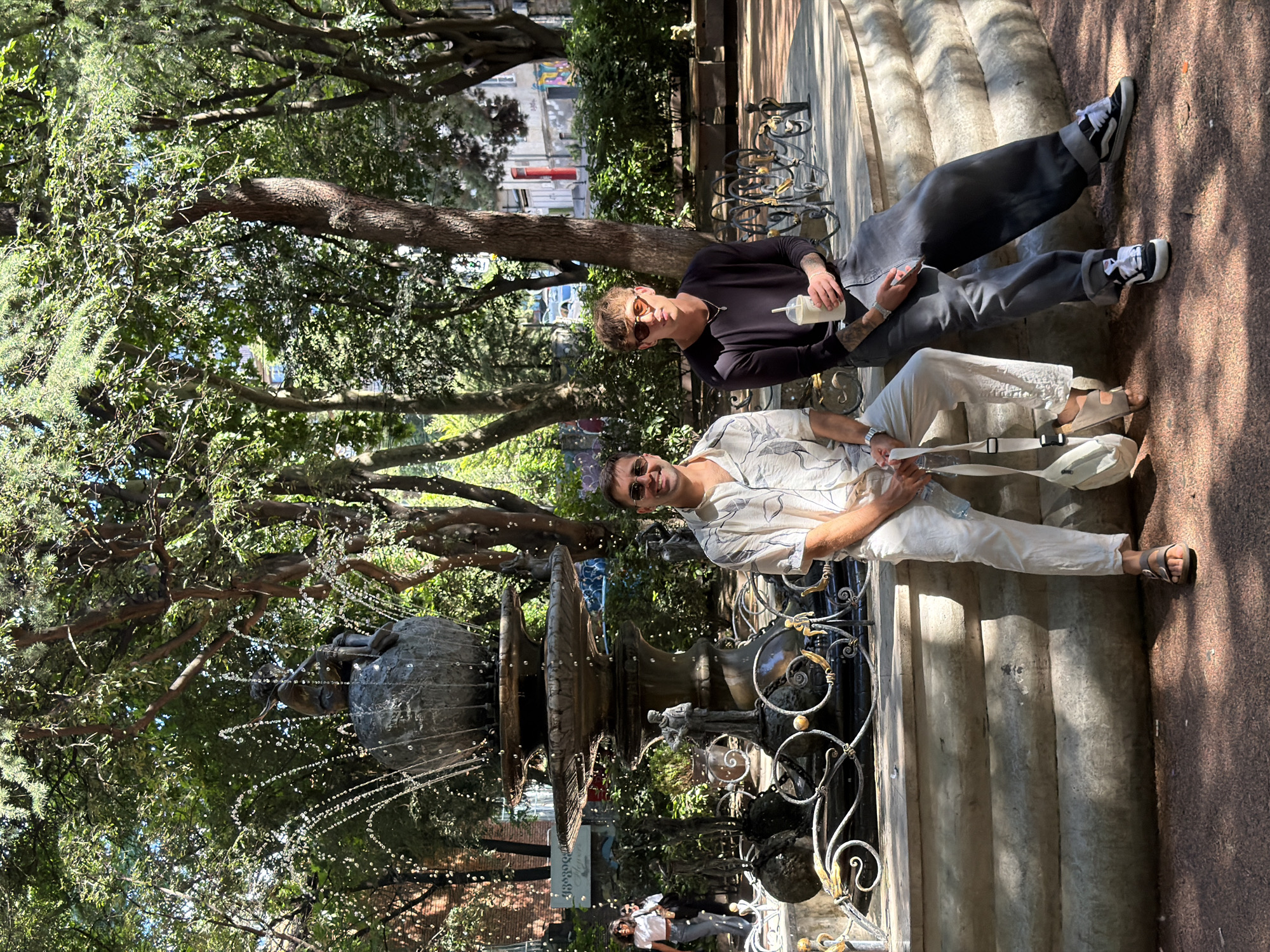 Afternoon in a Tbilisi park, around an ornate stone fountain