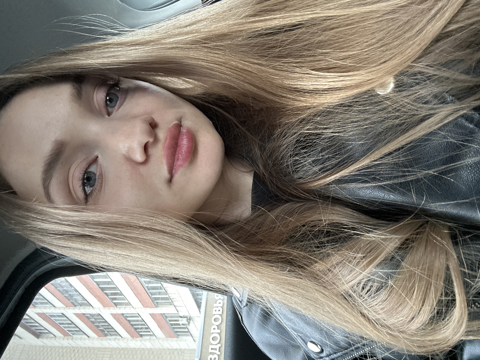 Woman takes selfie in black leather jacket in Kazan