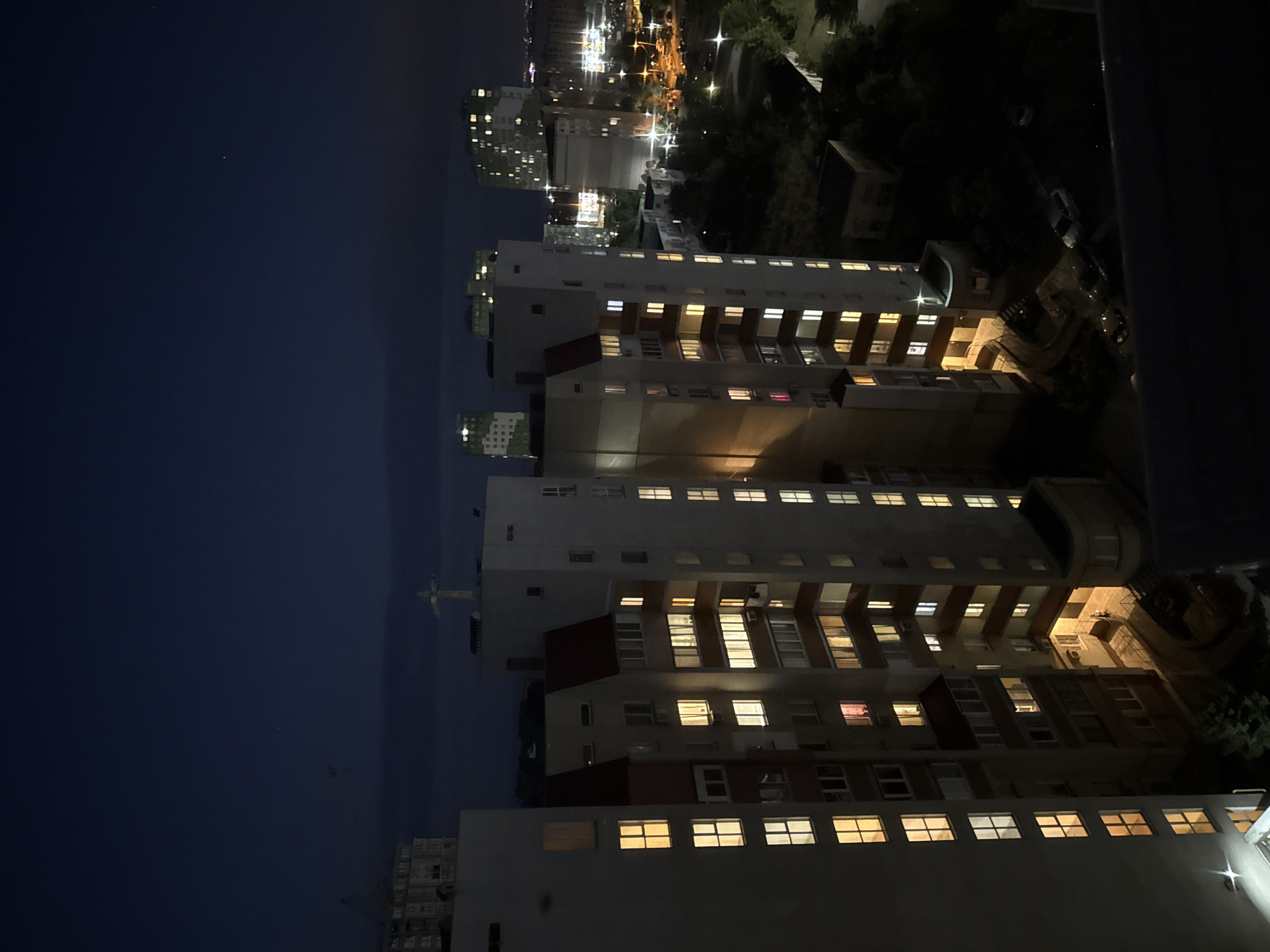 Orange moon rises over Odesa apartments on a summer night