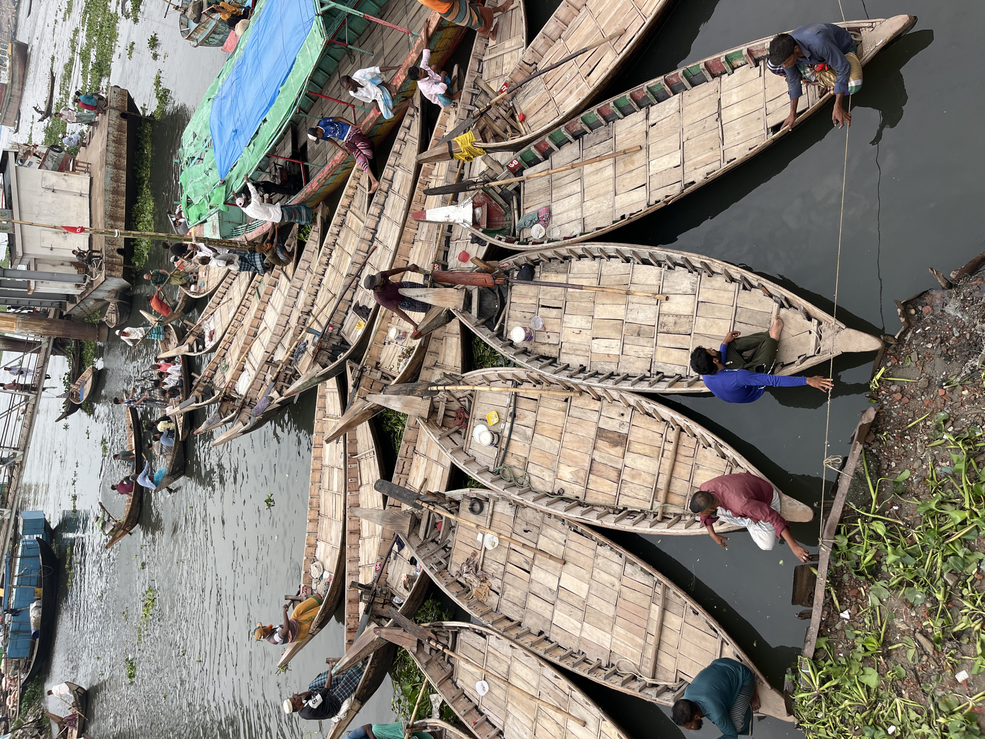 Morning commercial activity scenes documented across Dhaka waterways and streets