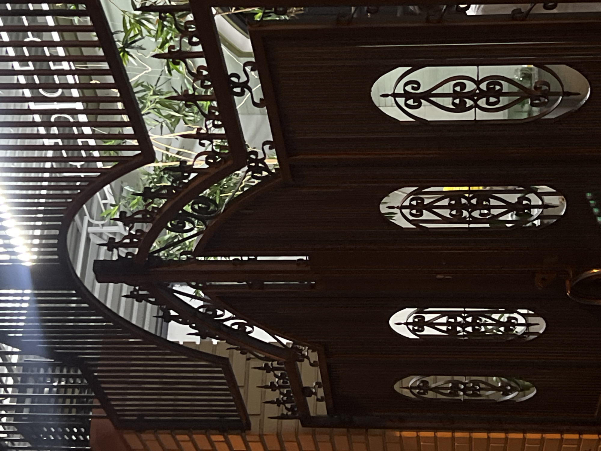 Ornate metalwork and street puddle documented in Nha Trang