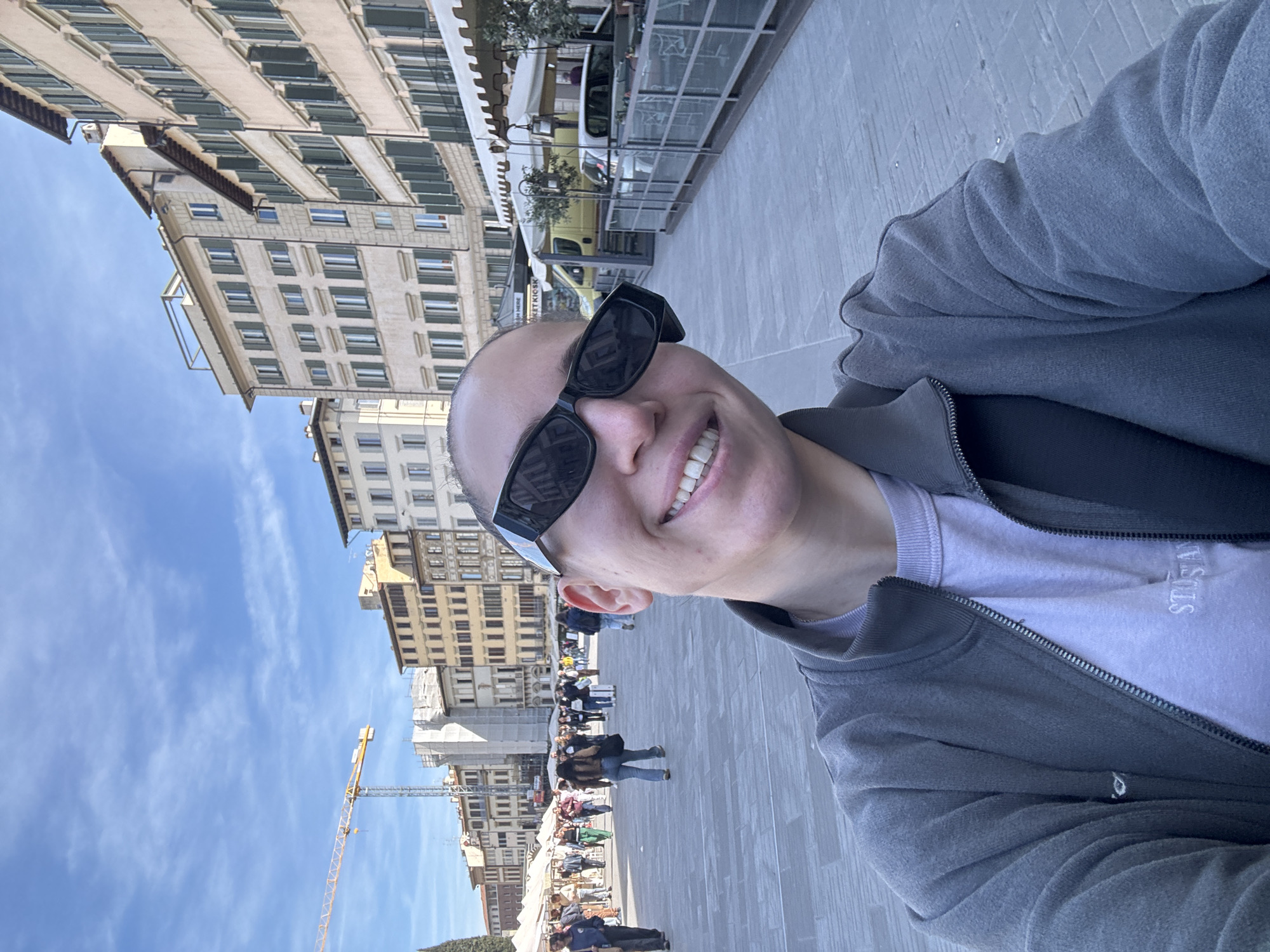 Tourist takes selfie in bustling Florence public square