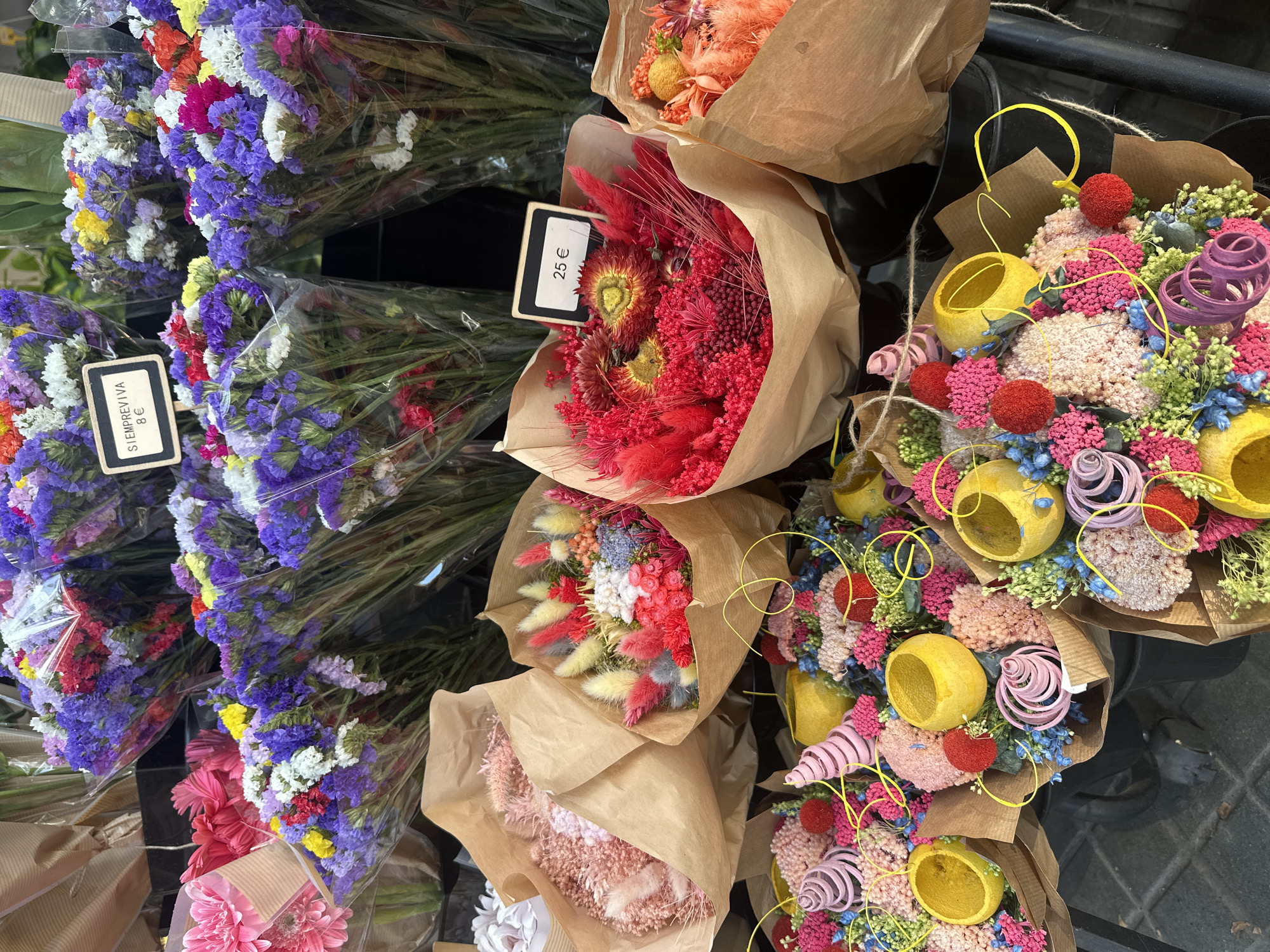 Browsing a colorful Barcelona flower stall, June afternoon