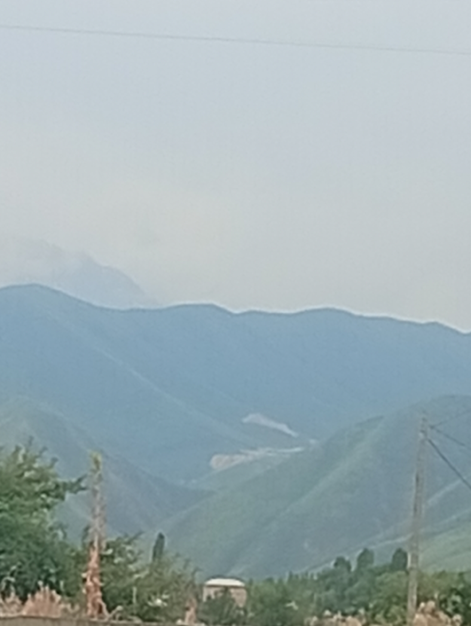 Rural Kyrgyzstan: green hills, mountain roads, and roaming horses