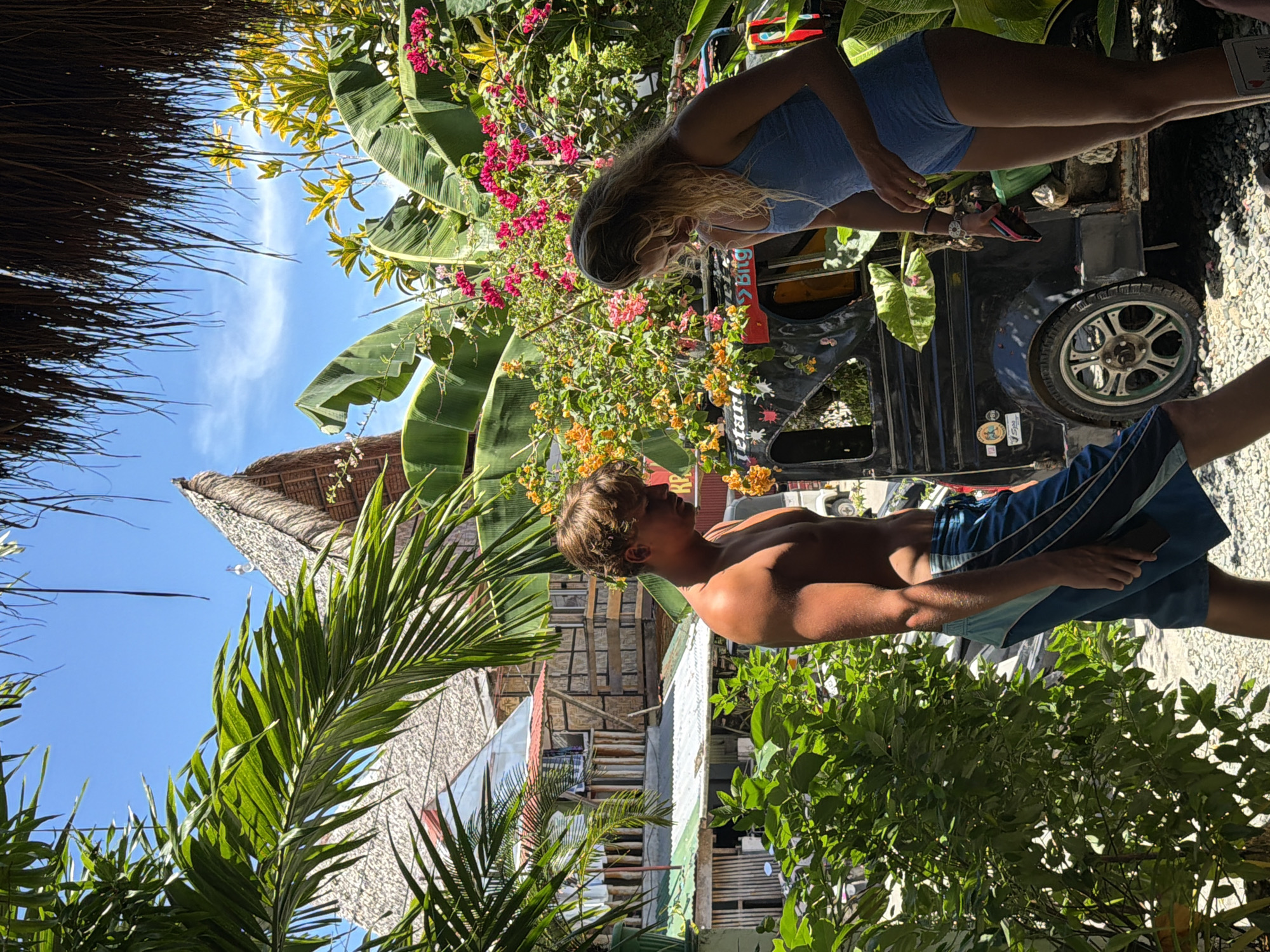 Tourists relax at tropical cafes in General Luna, Philippines