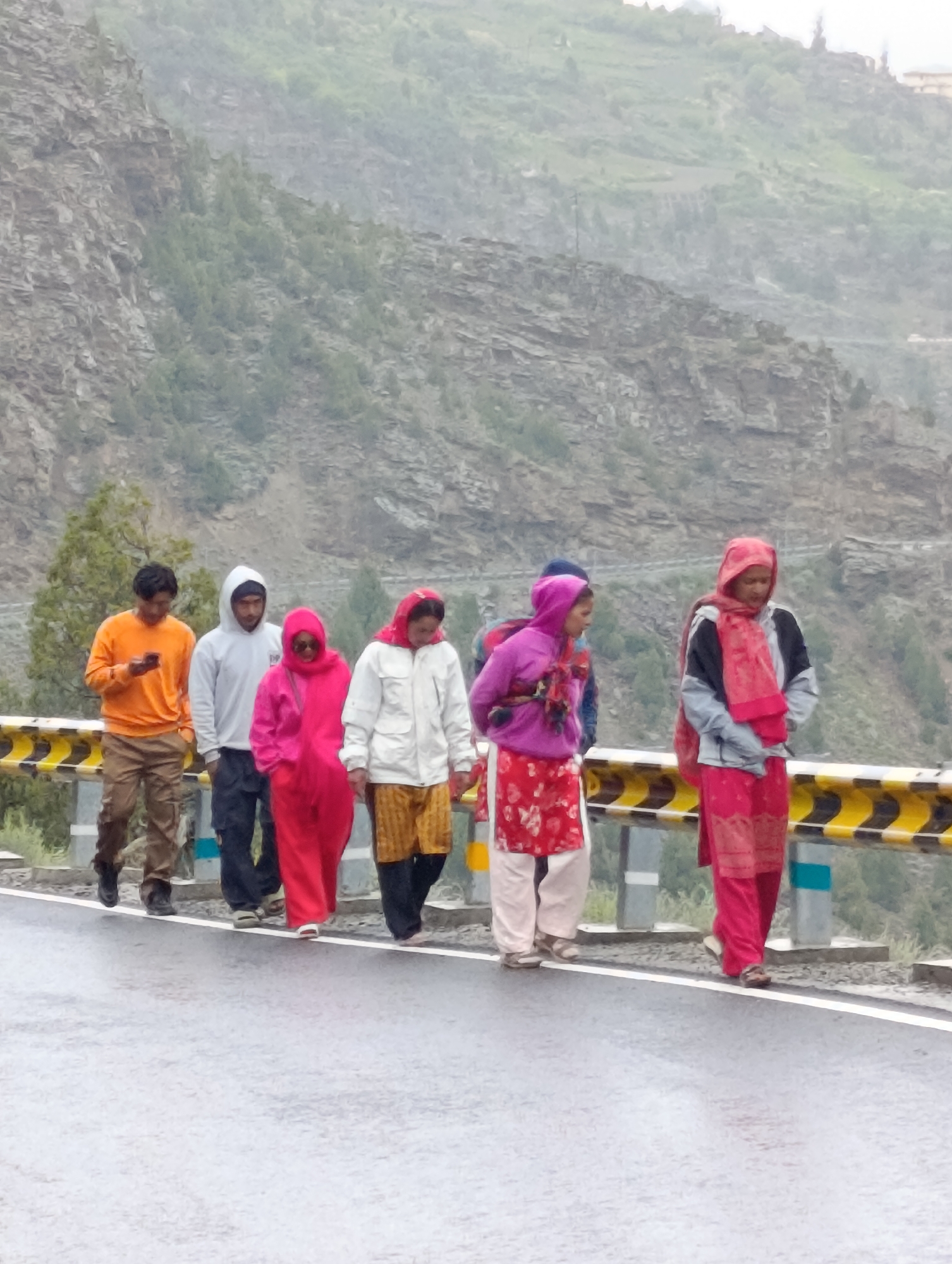 Rainy mountain road stop in Kead with Royal Enfields and valley views