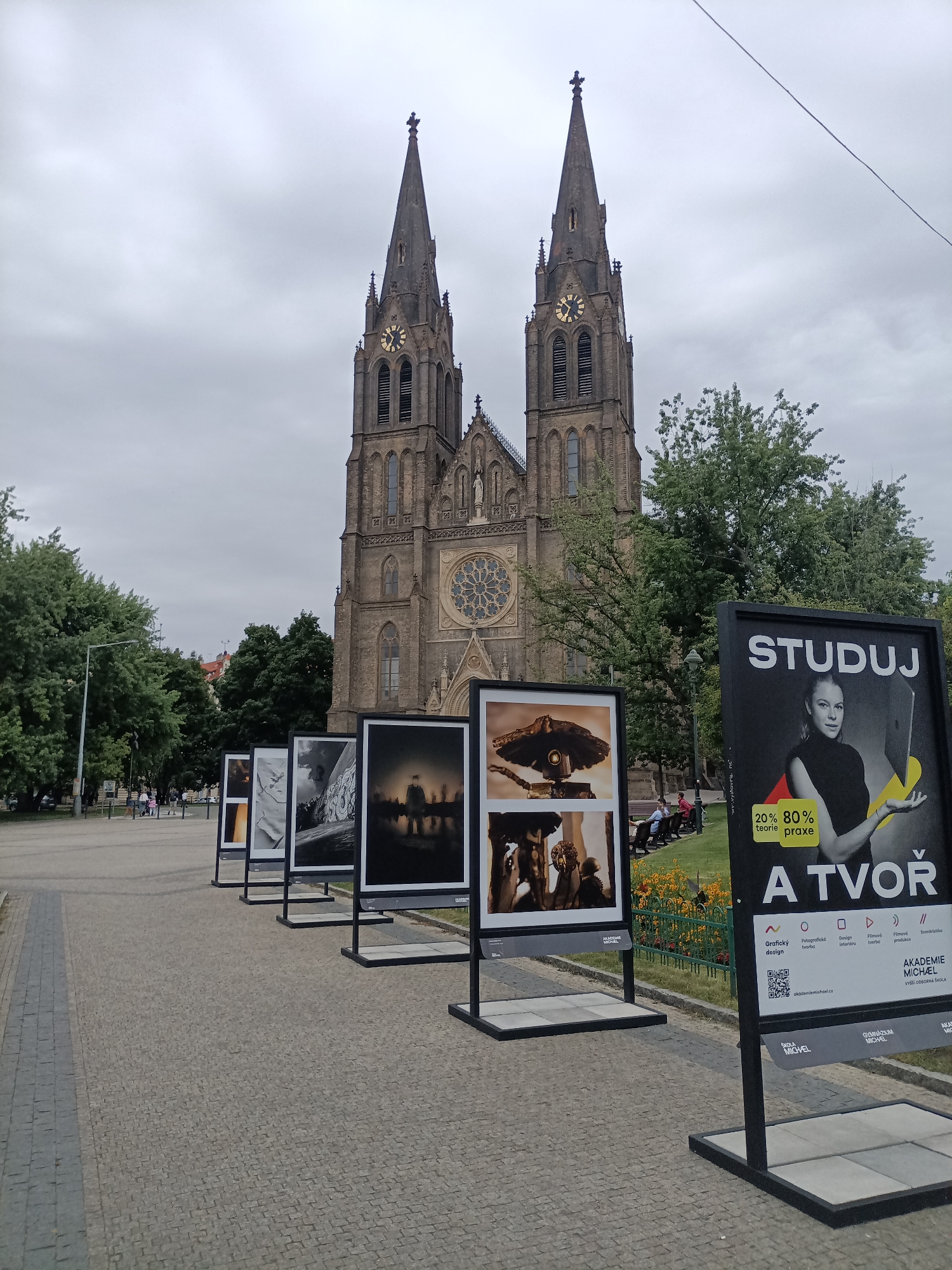 Prague streets, trams, and Vyšehrad basilica on a cloudy afternoon