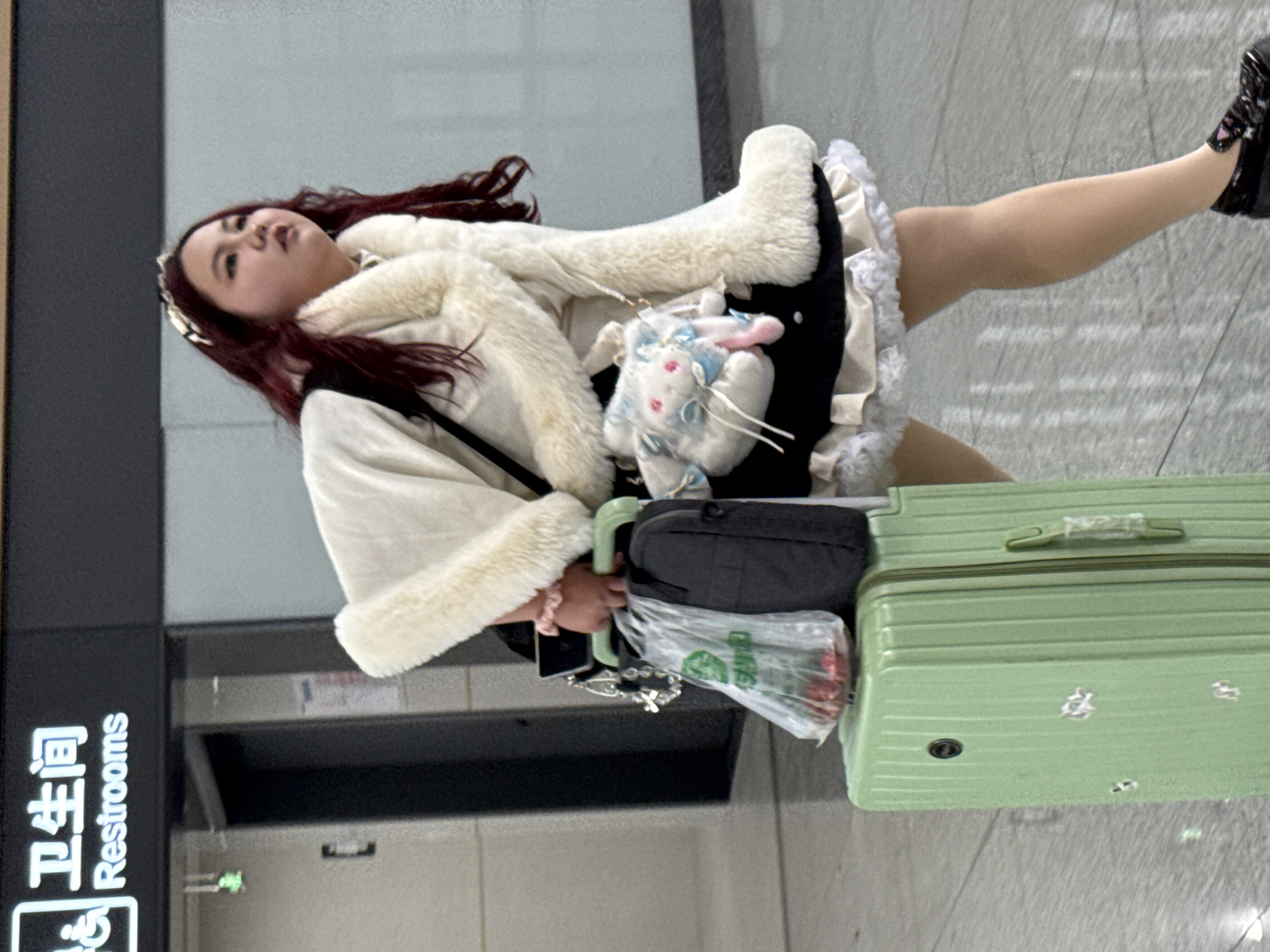 Woman with luggage spotted in public space in Qianjiang