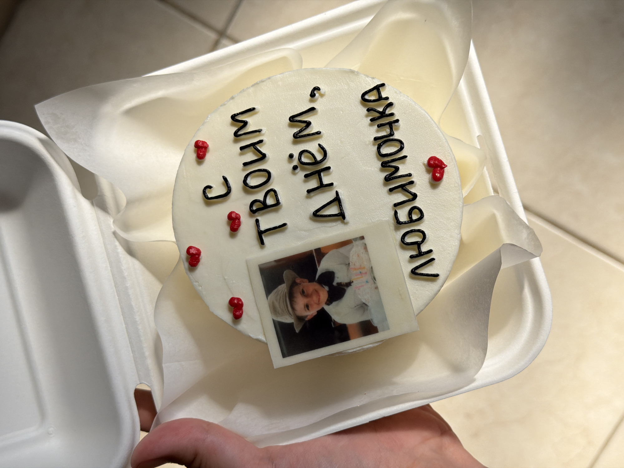 Personalized celebration cake with Polaroid photo topper in Tel Aviv