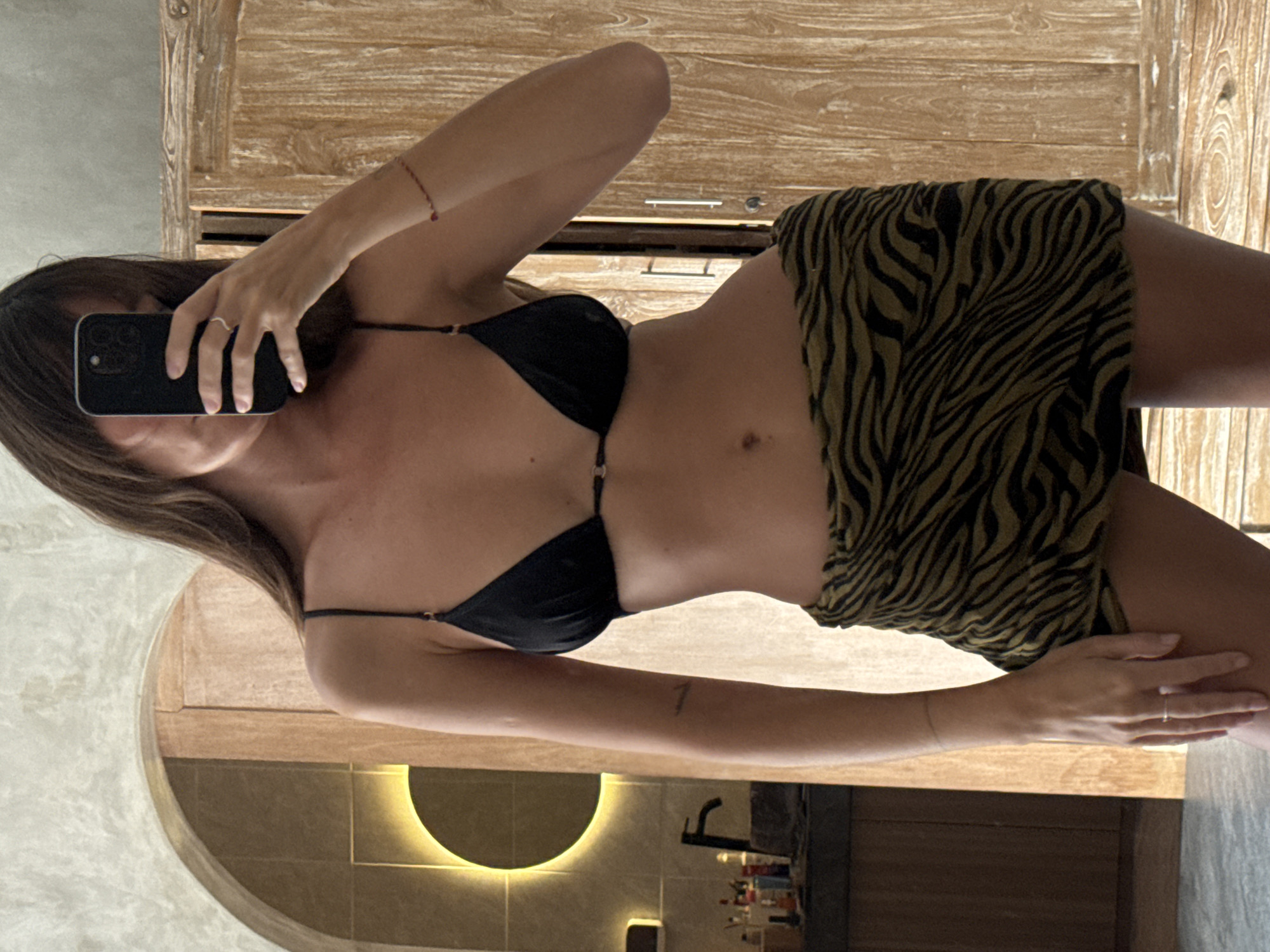 Woman Takes Mirror Selfie in North Kuta Bathroom