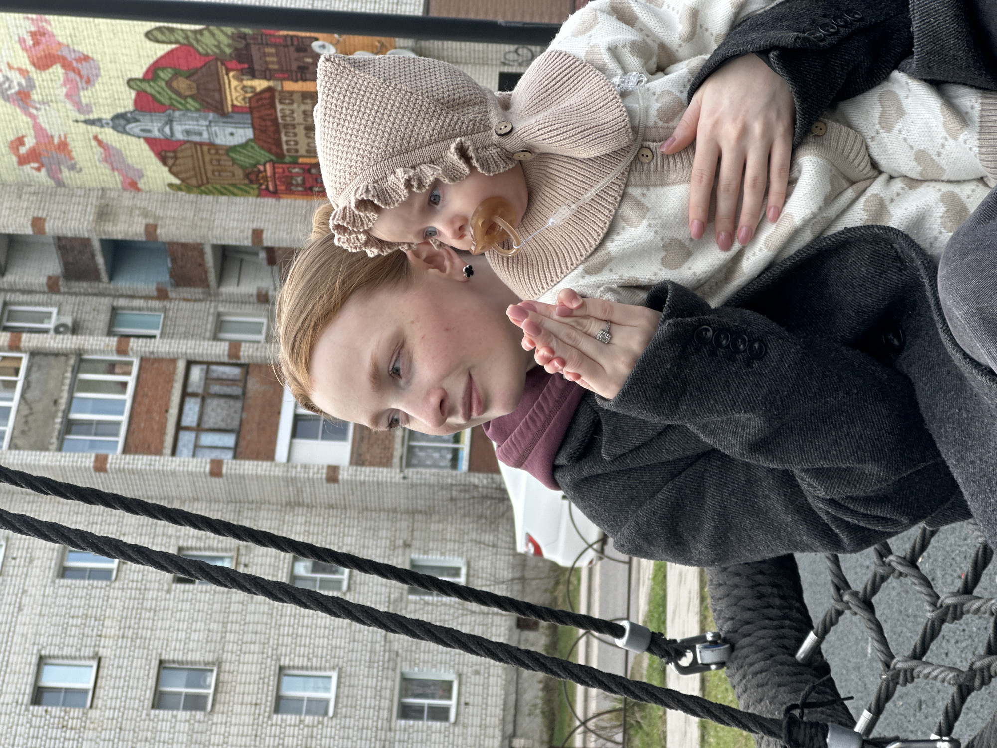 Mother and baby enjoy tire swing at Pokrov playground