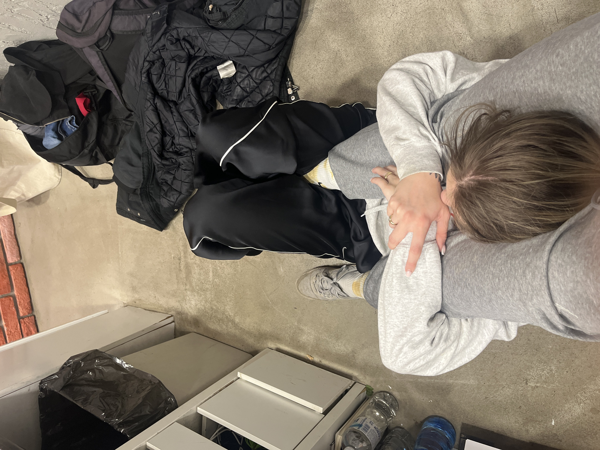Person rests on floor indoors in Sofia