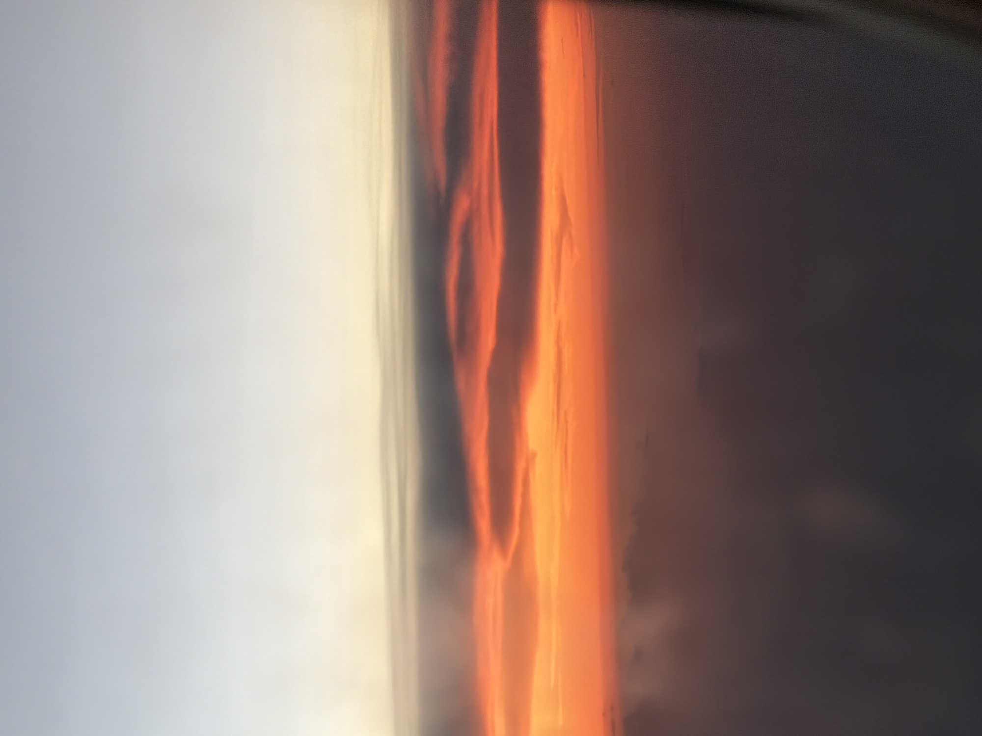 Orange sunset captured with vertical clouds in Choeng Thale