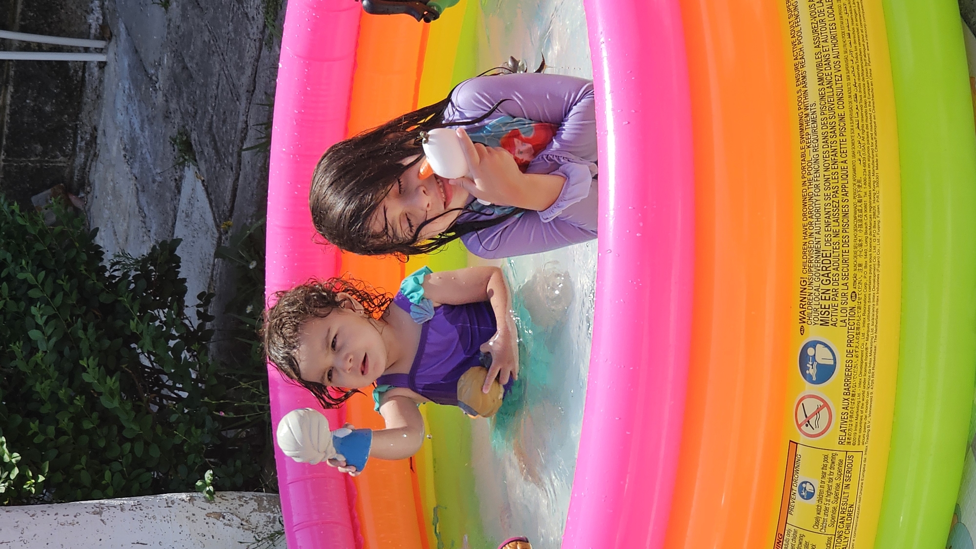 Children play in inflatable pool in Mexican backyard