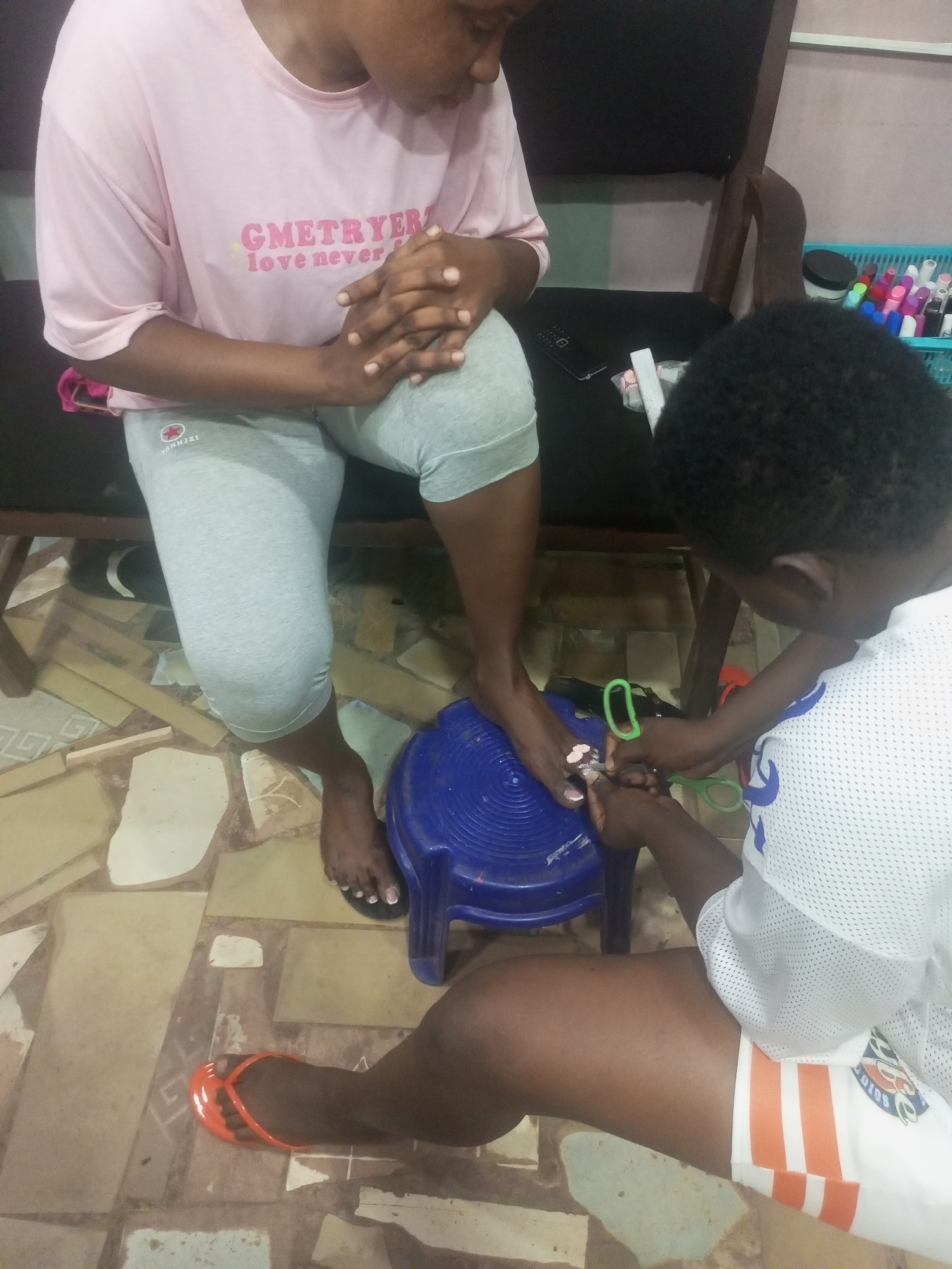 Indoor pedicure session between two people documented