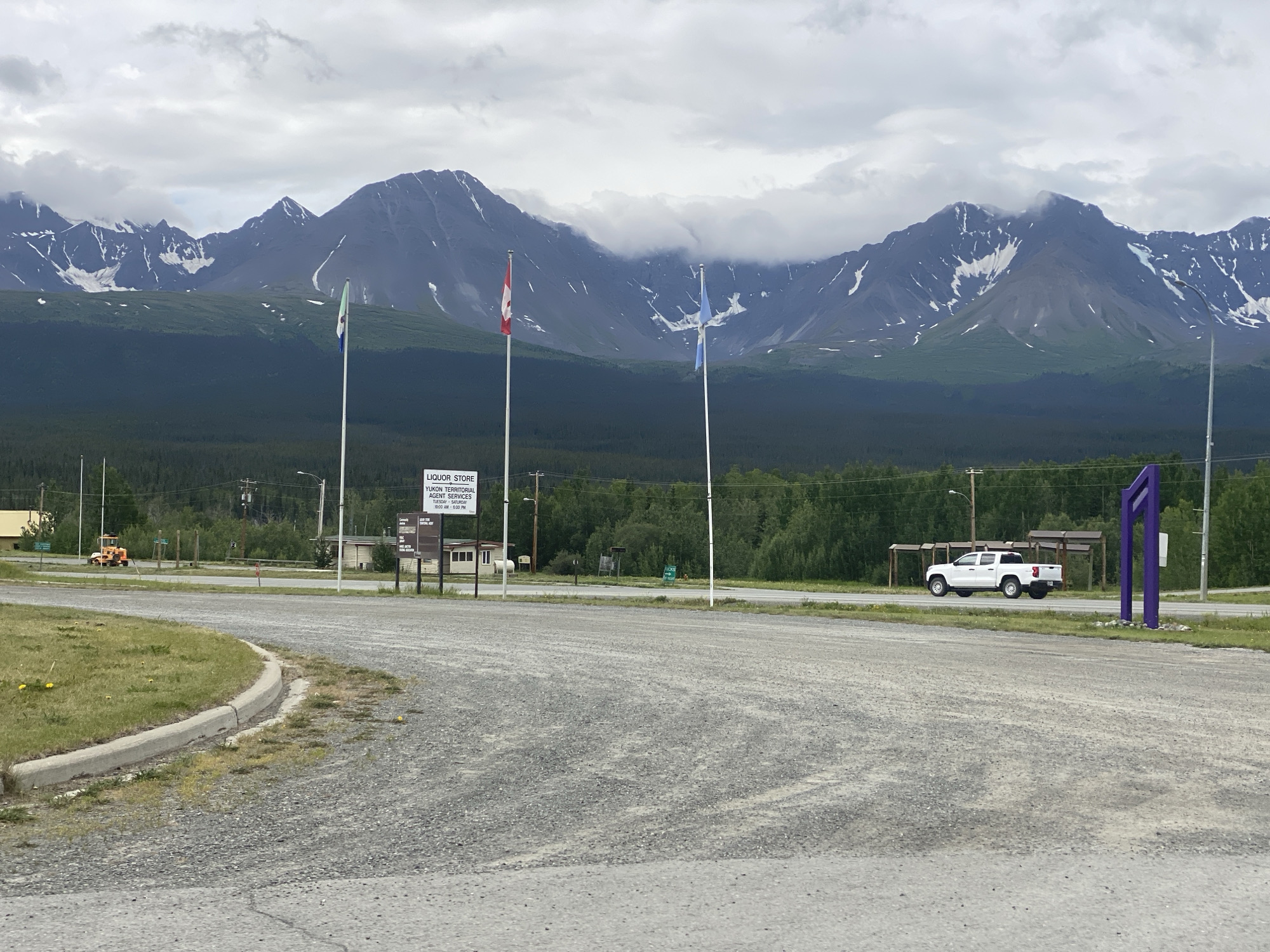 Haines Junction streets and mountains on a cloudy July day