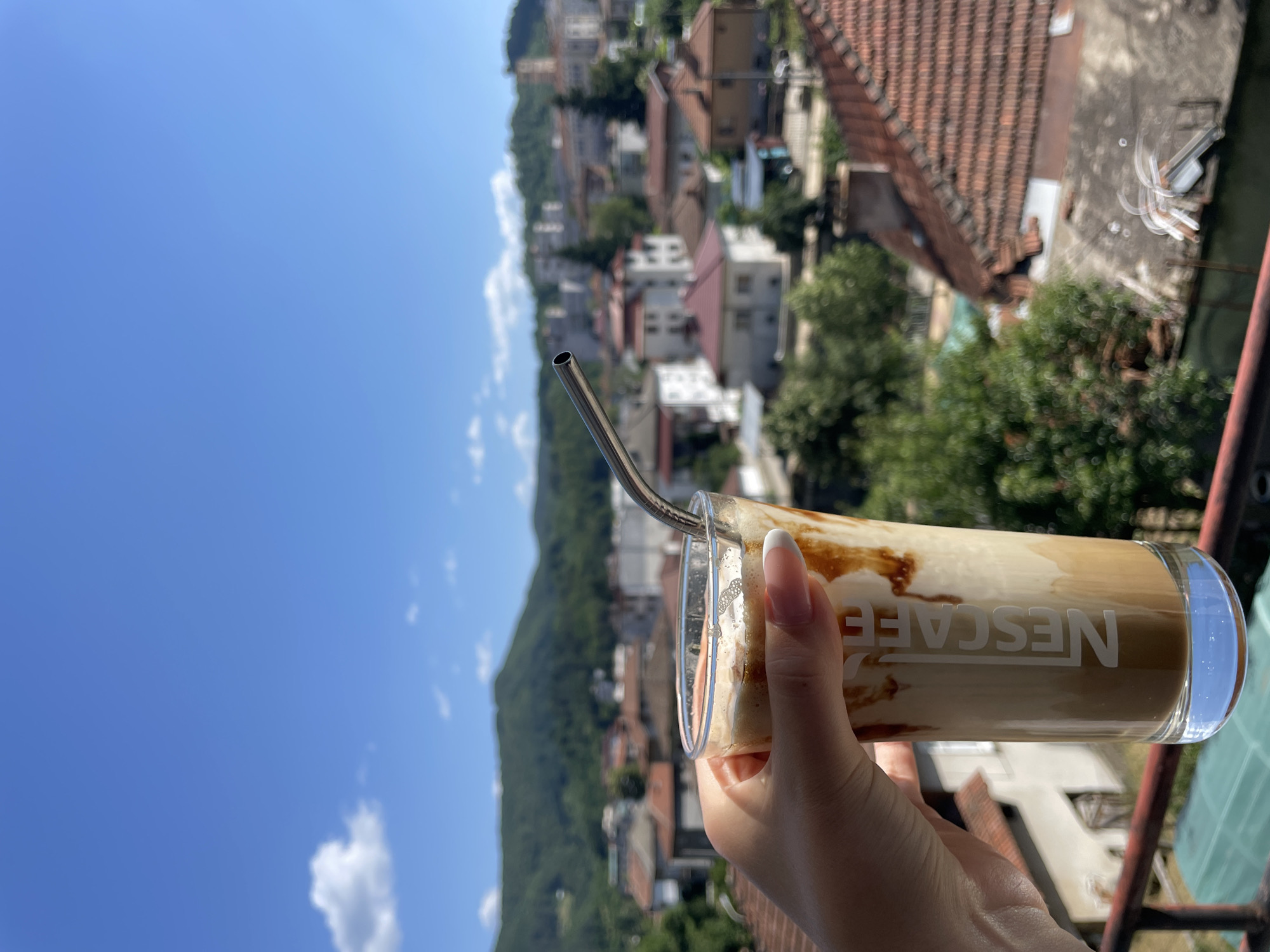 Balcony reading session in Zlatograd with iced coffee and Colleen Hoover