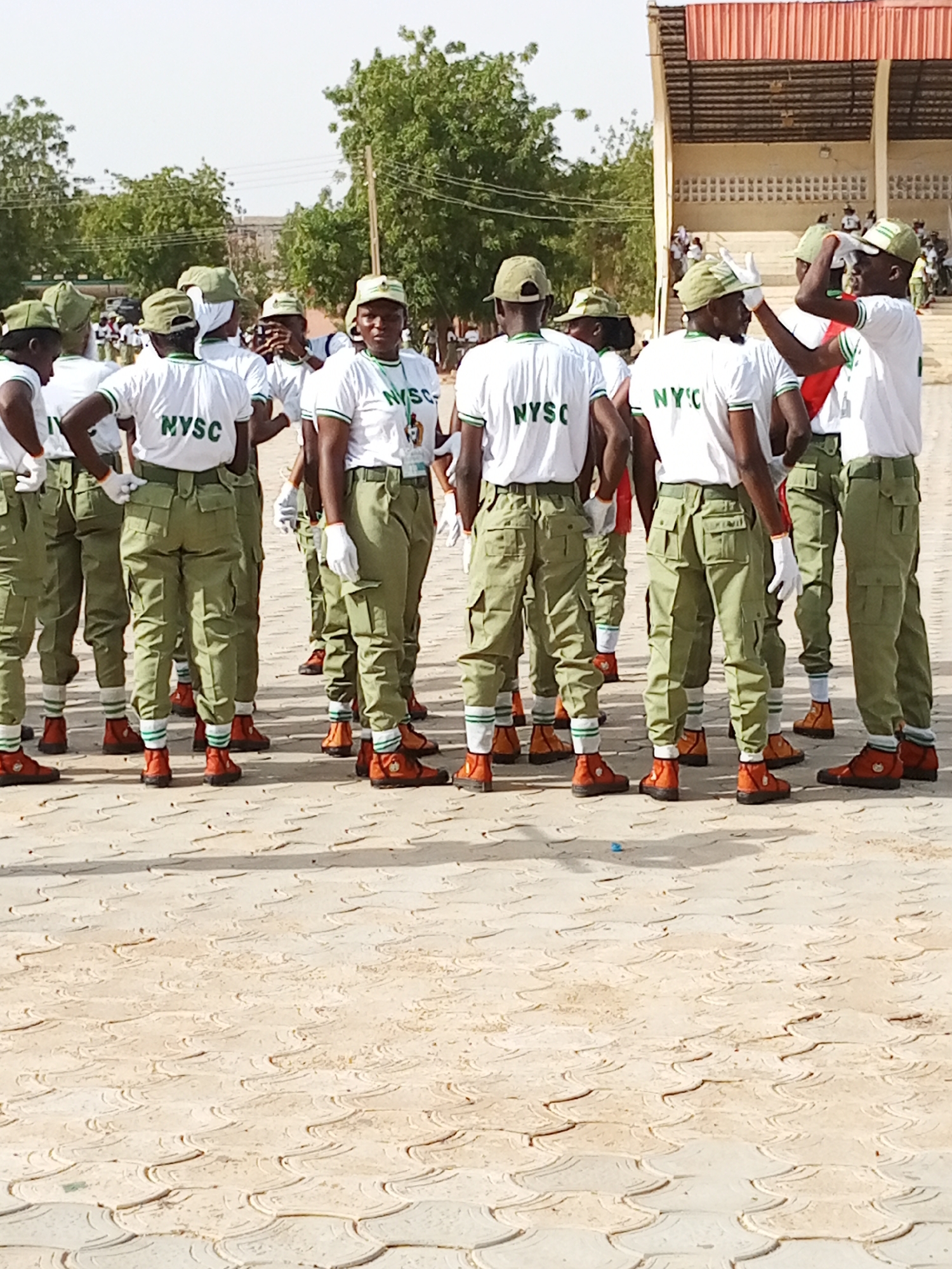 NYSC corps members in formation, drumming outdoors in Ajiwa